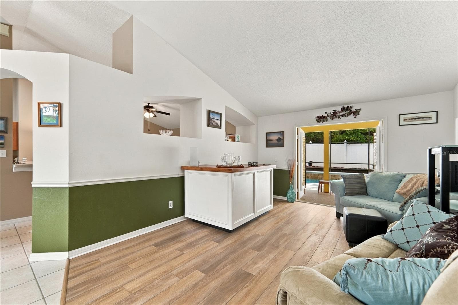 Living room with French doors out to the pool and screened porch - 1420 BENT OAKS BLVD, DELAND