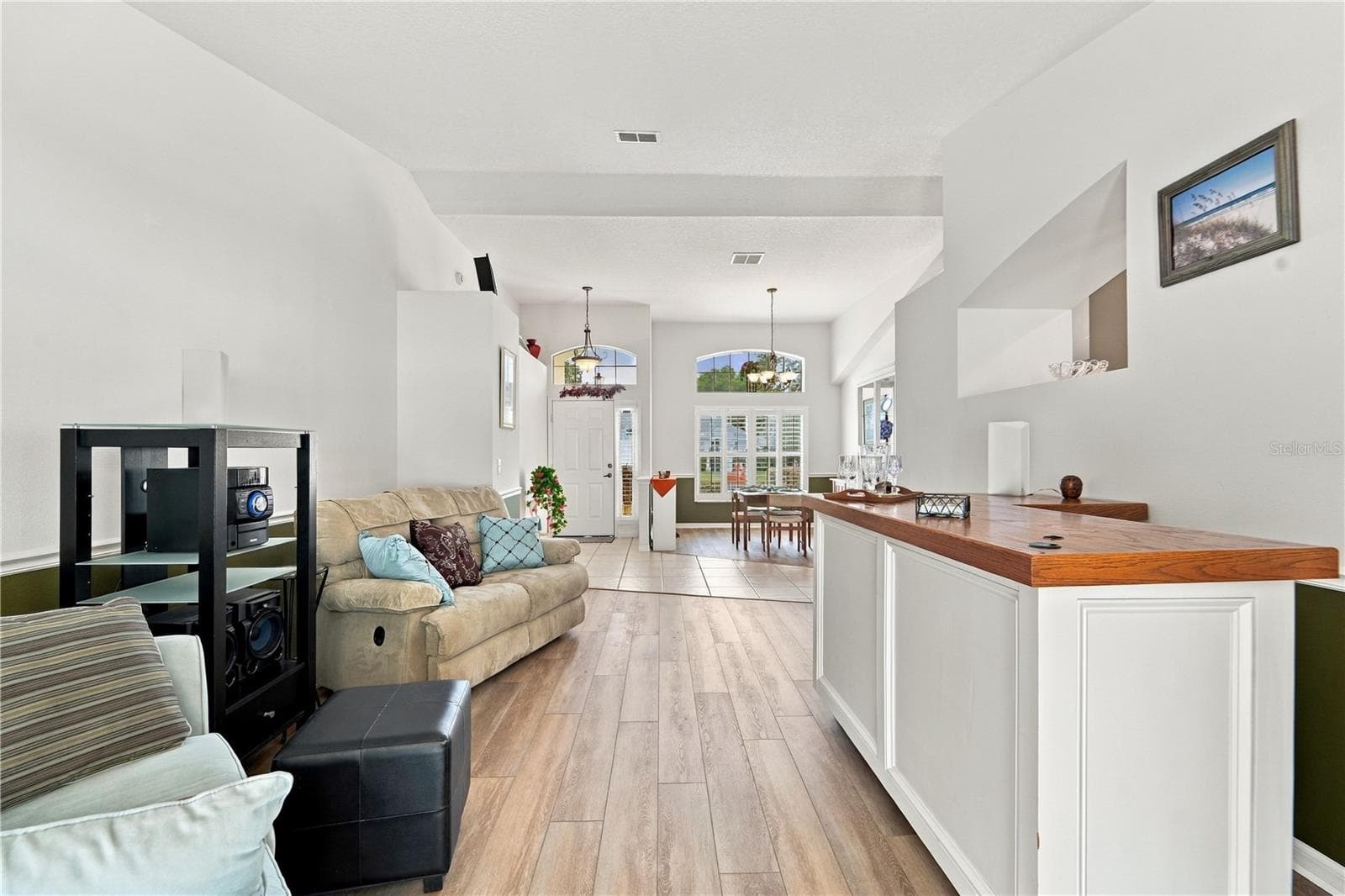 Looking from pool area towards front door and showing living room and dining room. - 1420 BENT OAKS BLVD, DELAND