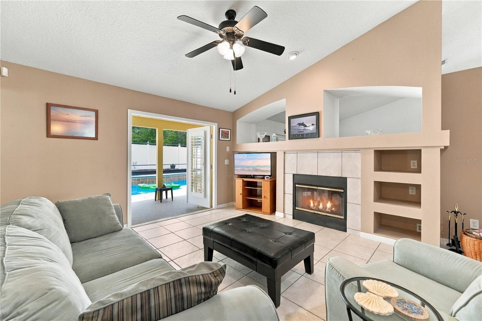 Family room with French doors open to the pool area. - 1420 BENT OAKS BLVD, DELAND