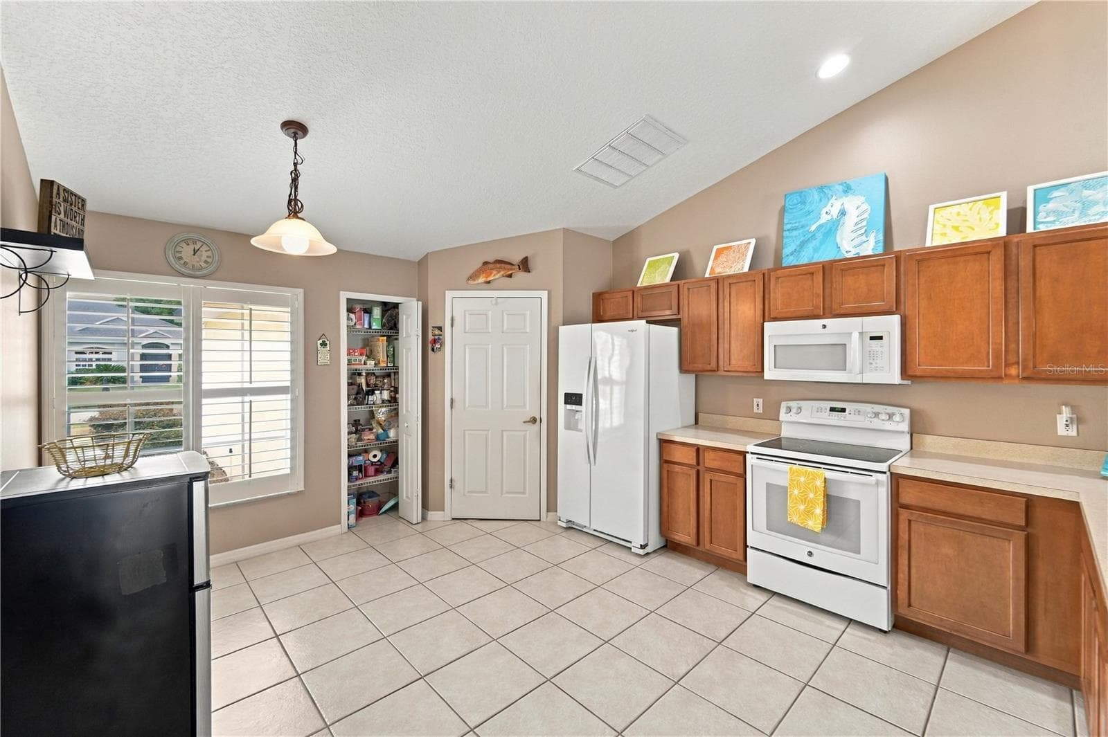 Spacious kitchen with plenty of cabinets, pantry and room for a breakfast nook table. Closed door is to separate laundry room. - 1420 BENT OAKS BLVD, DELAND