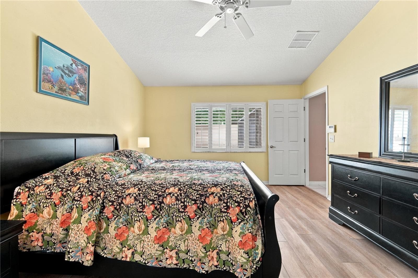 Primary bedroom with luxury vinyl plank flooring. - 1420 BENT OAKS BLVD, DELAND