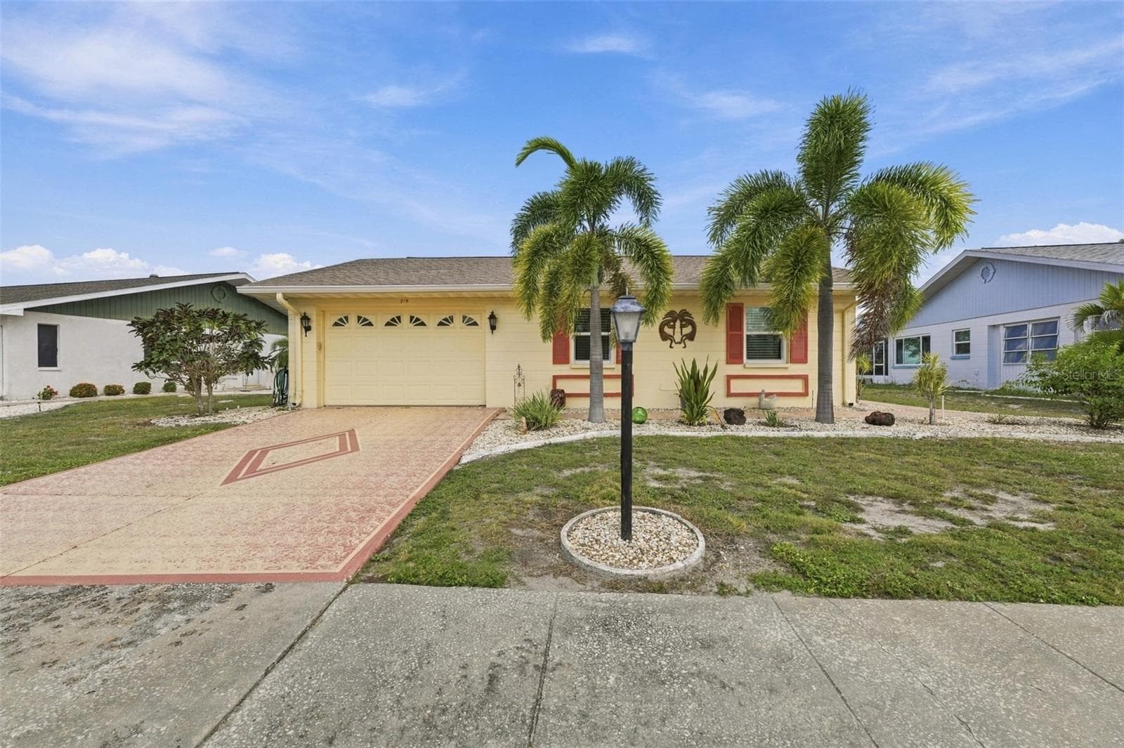 Simple landscaping for easy maintenance and sidewalks for safety. - 215 GENET CT, SUN CITY CENTER