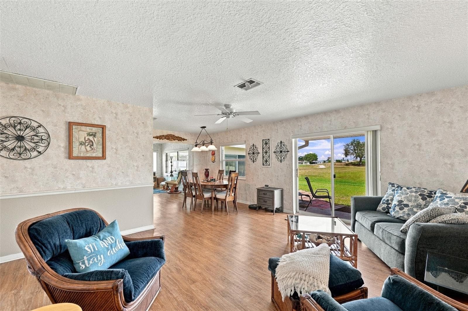As you walk into the home, it is an open floor plan with lots of natural Florida sunshine filtering in through the new impact windows. - 215 GENET CT, SUN CITY CENTER