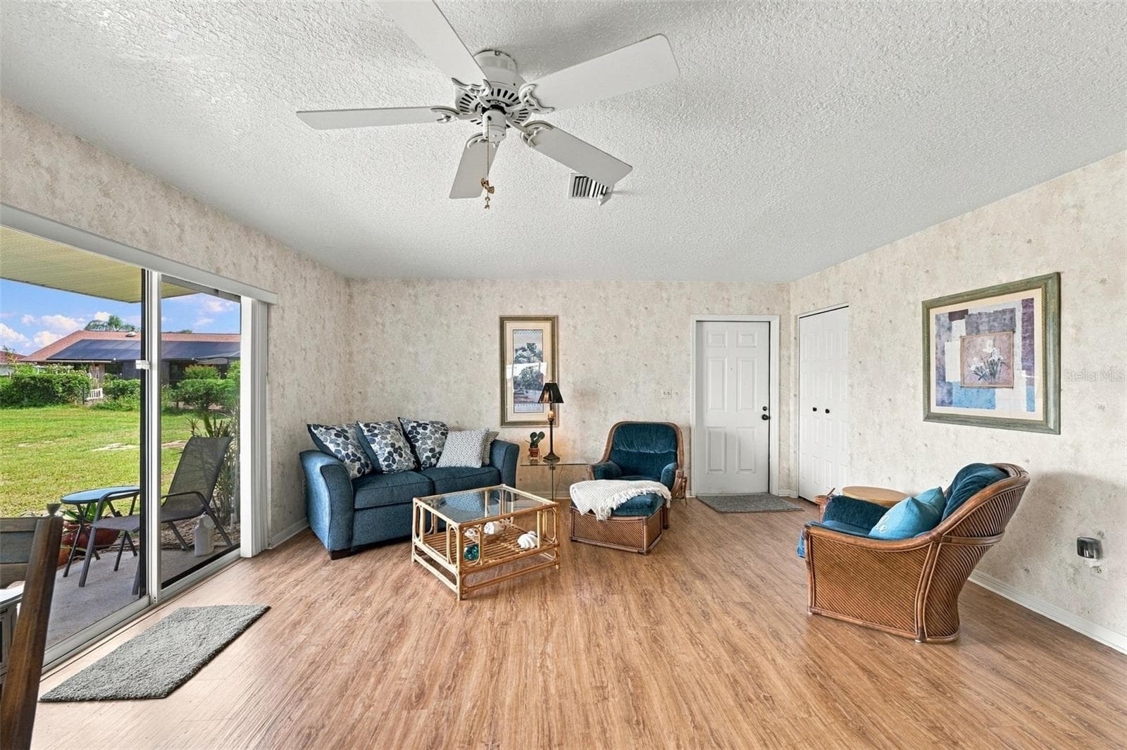 The living room is spacious and open with a full view of the greenbelt and wildlife activity. - 215 GENET CT, SUN CITY CENTER