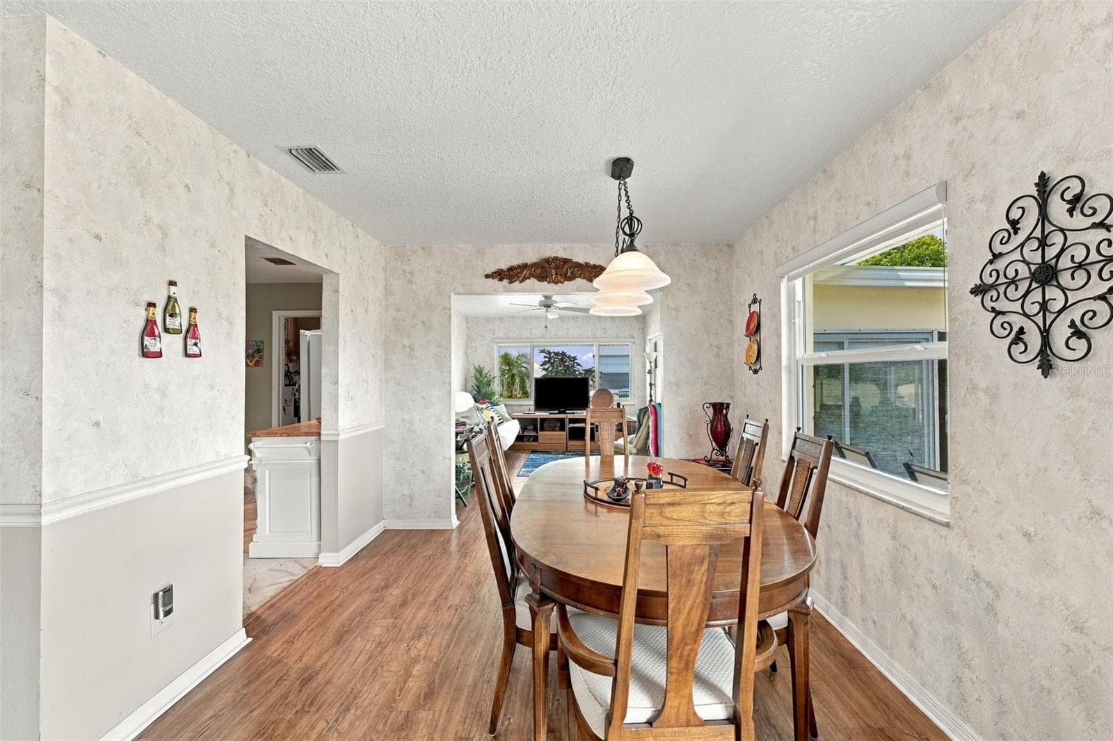 The dining area next to the large new window is the perfect spot to enjoy a meal or puzzle. - 215 GENET CT, SUN CITY CENTER