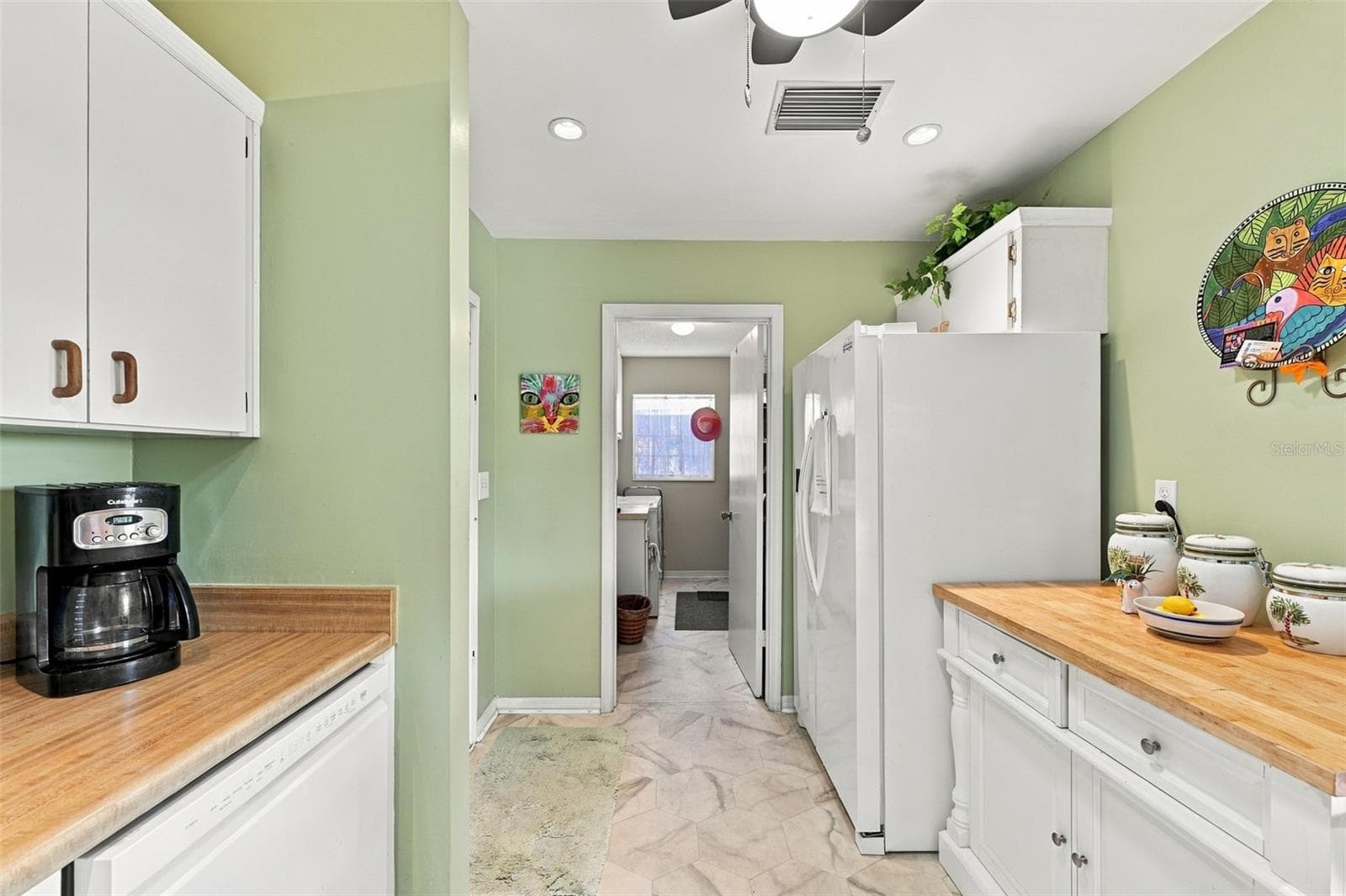 The kitchen feeds right into the inside laundry/storage room. - 215 GENET CT, SUN CITY CENTER