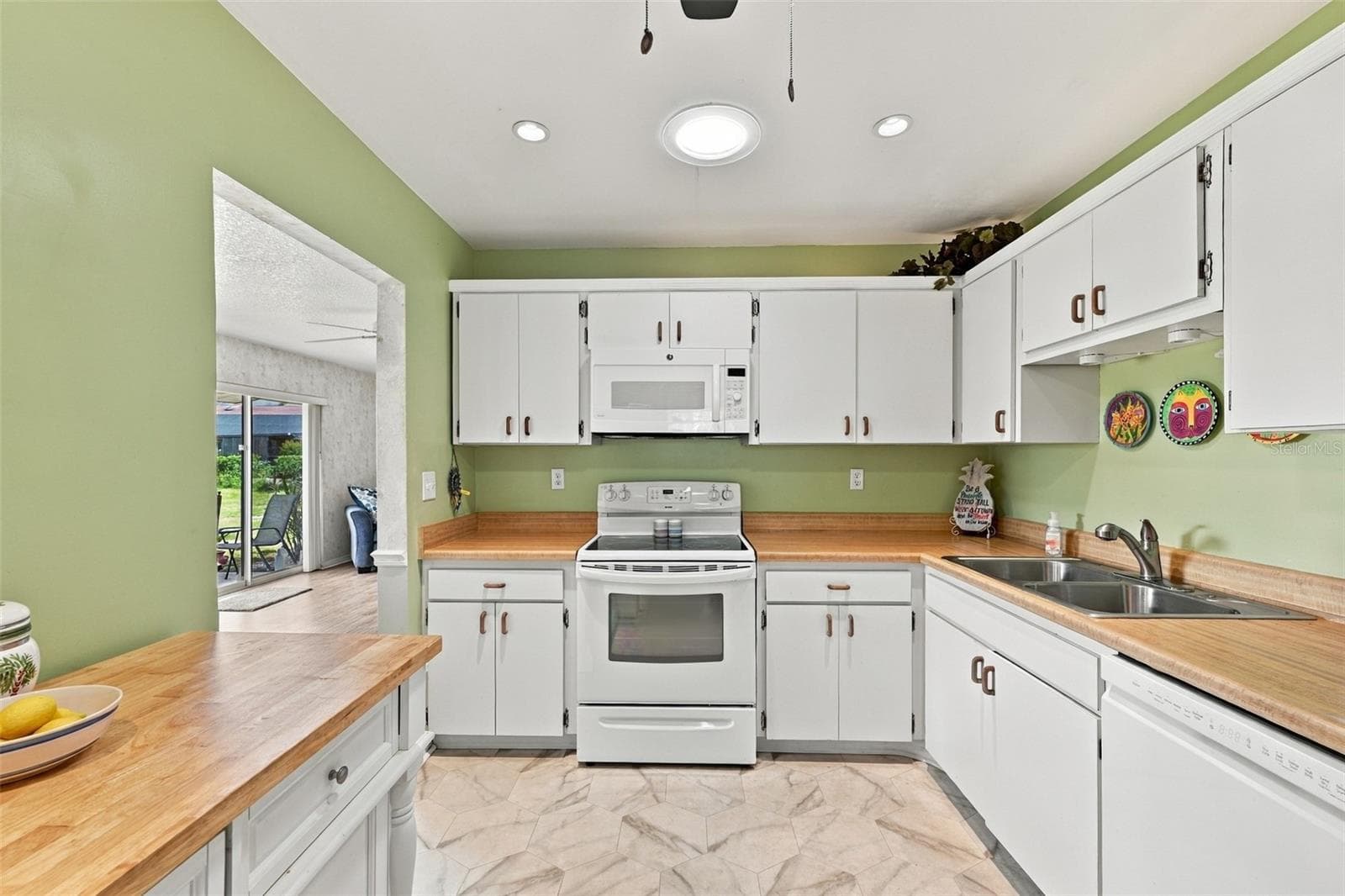 Florida muted tones and crisp bright white accents are placed throughout the kitchen. - 215 GENET CT, SUN CITY CENTER