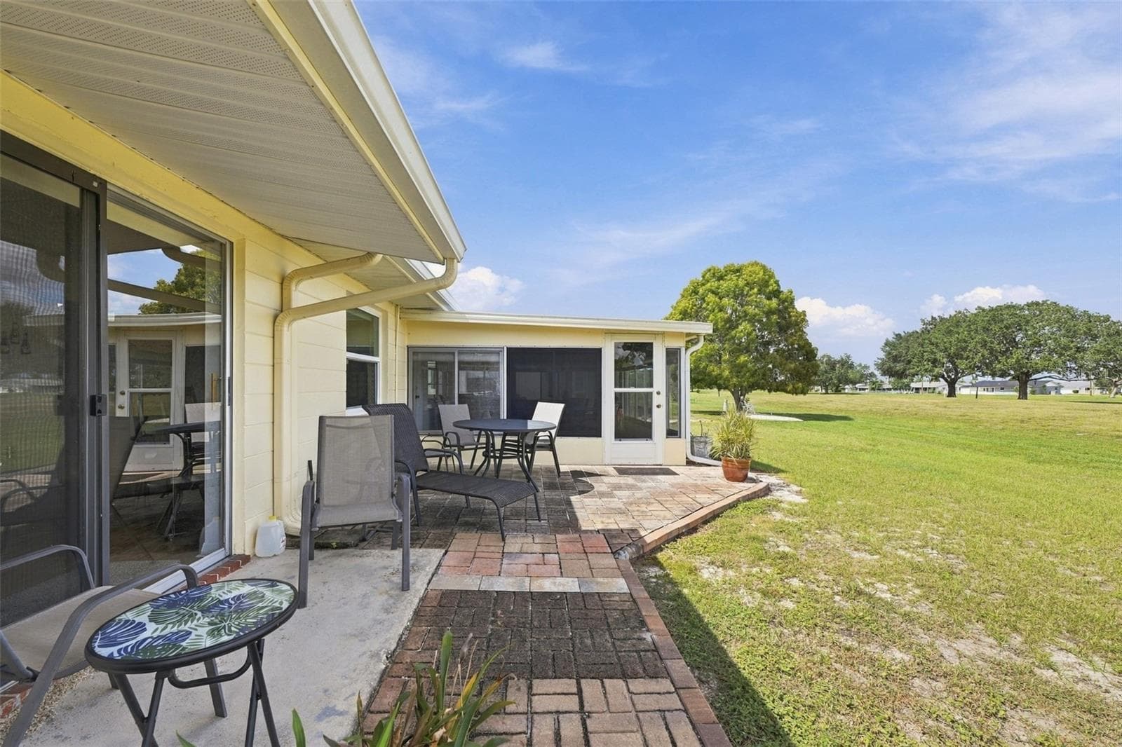 A large open air patio is perfect for grilling or enjoying the sun. - 215 GENET CT, SUN CITY CENTER