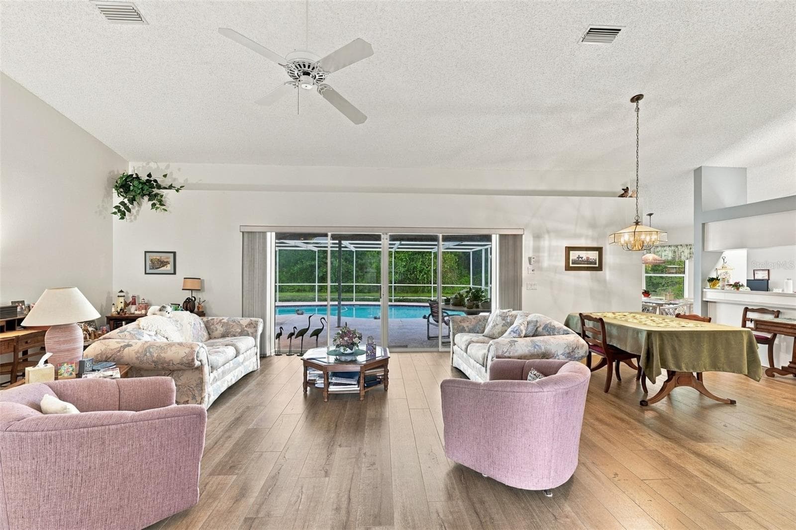 Living room area with access to pool - 8657 CYPRESS LAKES BLVD, NEW PORT RICHEY