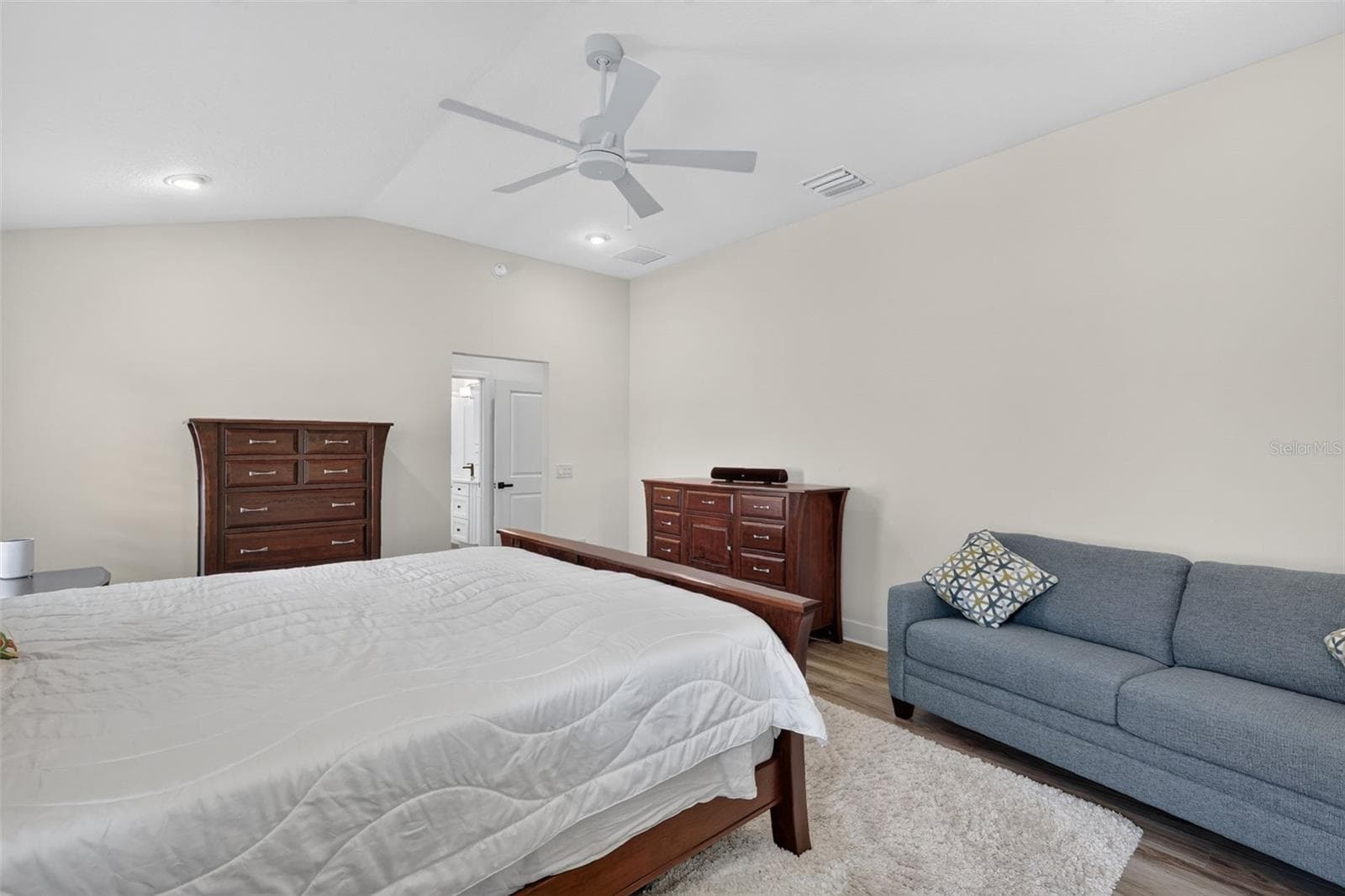Primary bedroom with view to the walk-in closet and en-suite bath - 2741 DUNHAM DR, THE VILLAGES