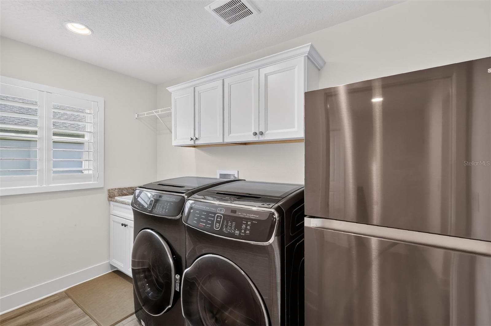 Laundry with utility sink and refrigerator - 2741 DUNHAM DR, THE VILLAGES