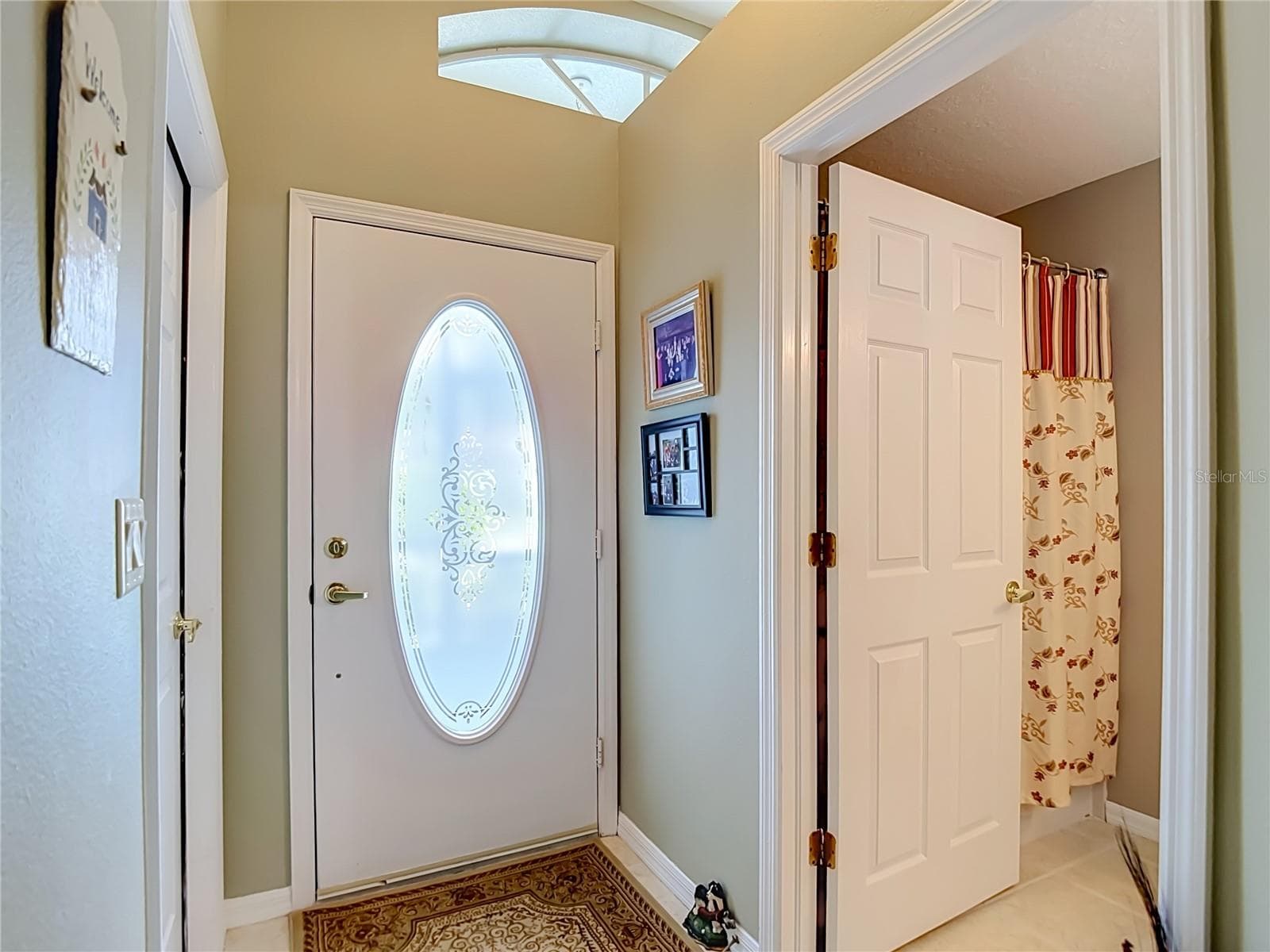 As you enter the open door is to bathroom 2. To the right is the door out to the garage. - 13424 NORMAN CIR, HUDSON