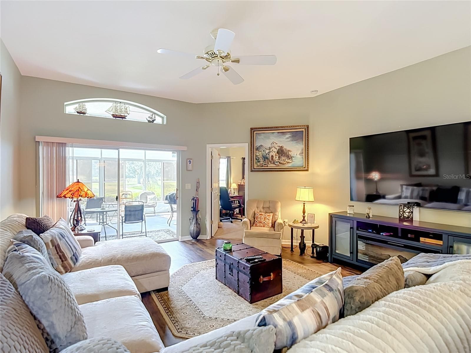 The living room is off the dining room and opens into the primary bedroom and patio ares. Room can accomodate oversized furniture with room to spare. - 13424 NORMAN CIR, HUDSON