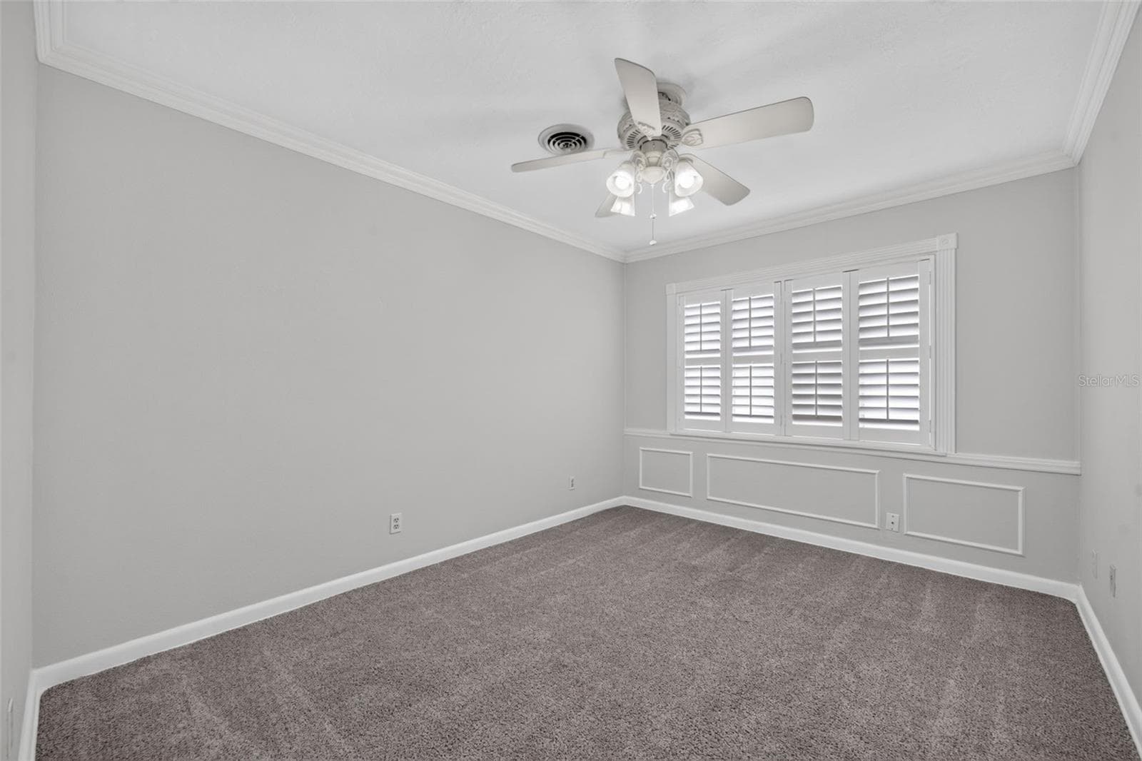 Alternate Bedroom — Ample-sized alternate bedroom with neutral carpeting, crown molding and custom interior shutters. - 200 SENECA TRL, MAITLAND