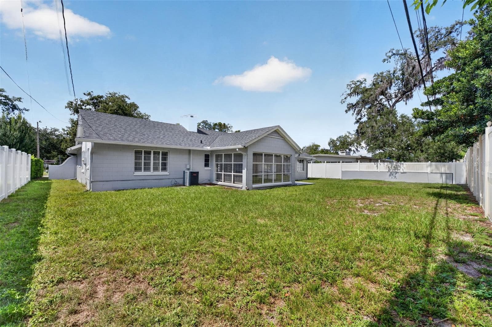 Rear Exterior — Generous fenced backyard with open lawn and plenty of room for outdoor enjoyment. - 200 SENECA TRL, MAITLAND