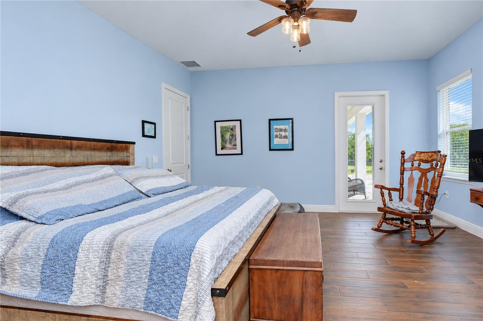 Primary Bedroom with door leading to pool - 5746 FRONTIER DR, ZEPHYRHILLS