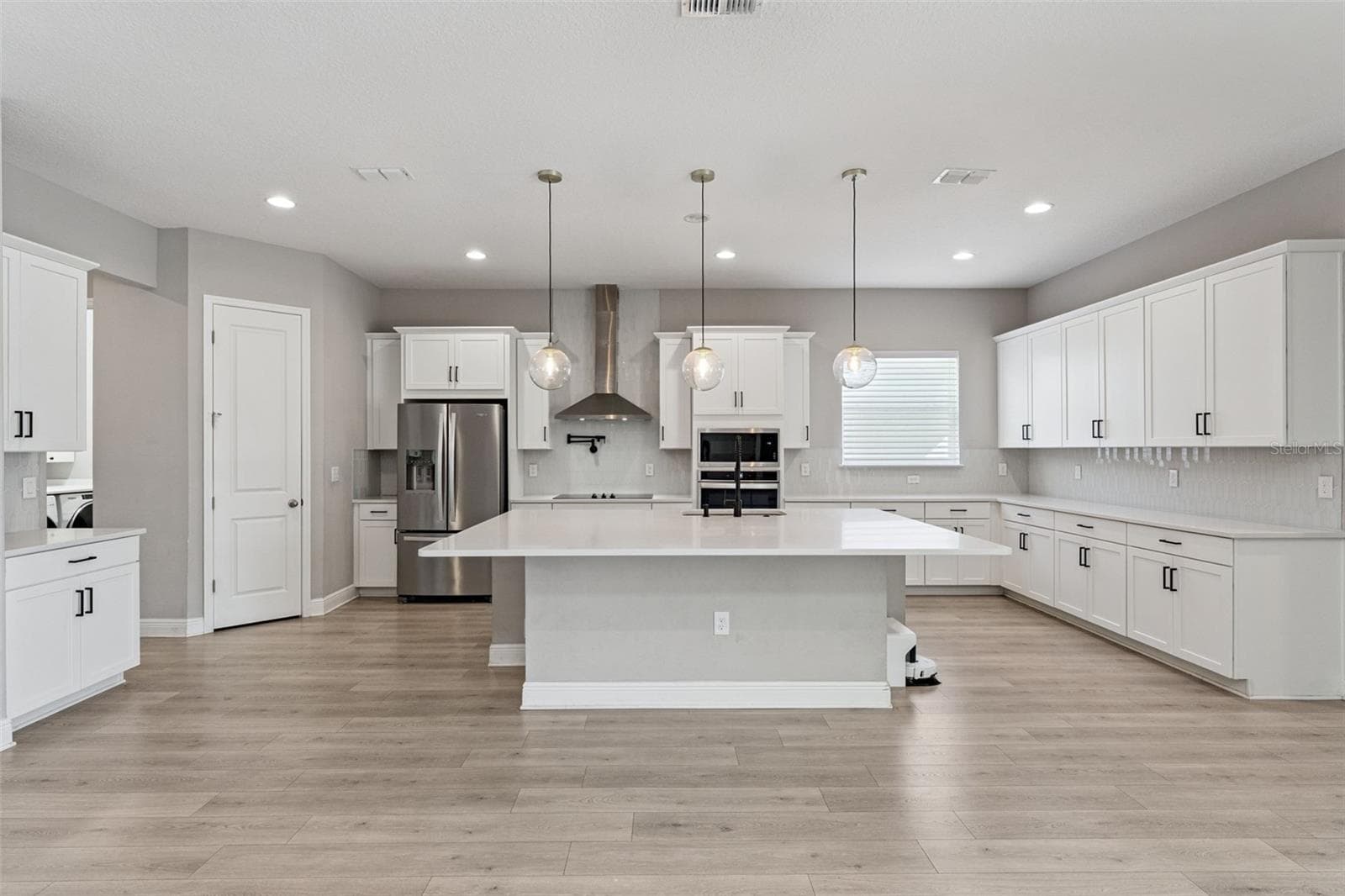 Bright kitchen featuring a large island and open-concept layout. - 19058 PLANETREE ST, ORLANDO