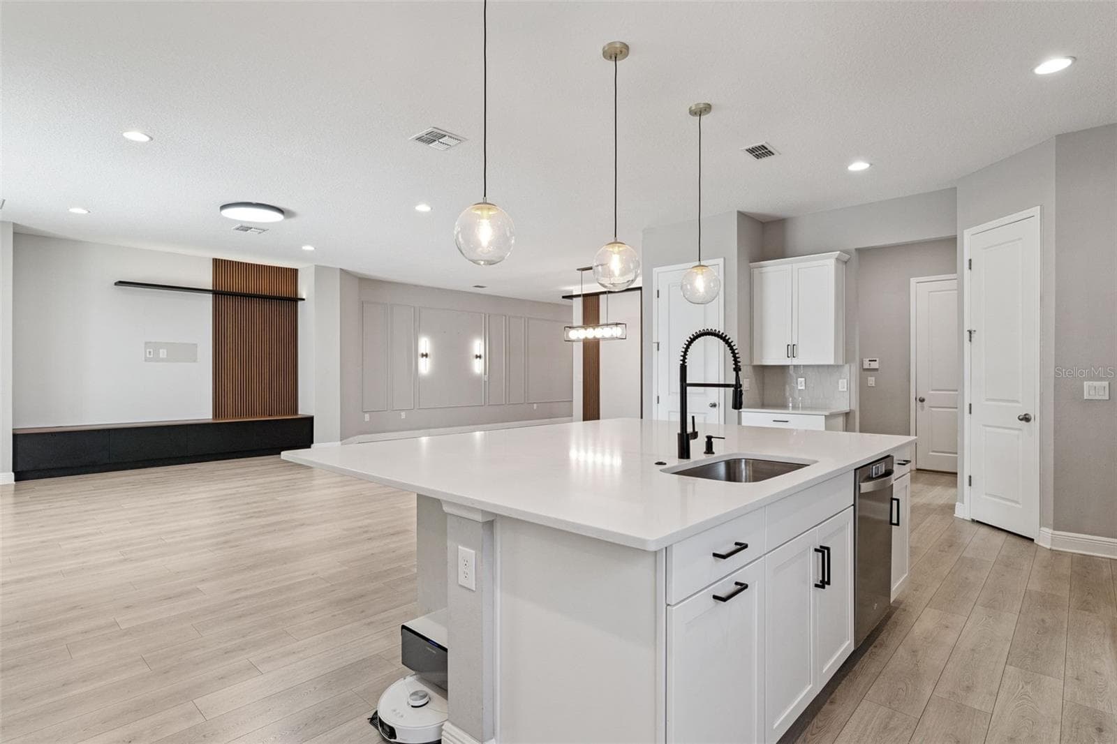 Modern kitchen with abundant cabinetry, counter space, and natural light. - 19058 PLANETREE ST, ORLANDO