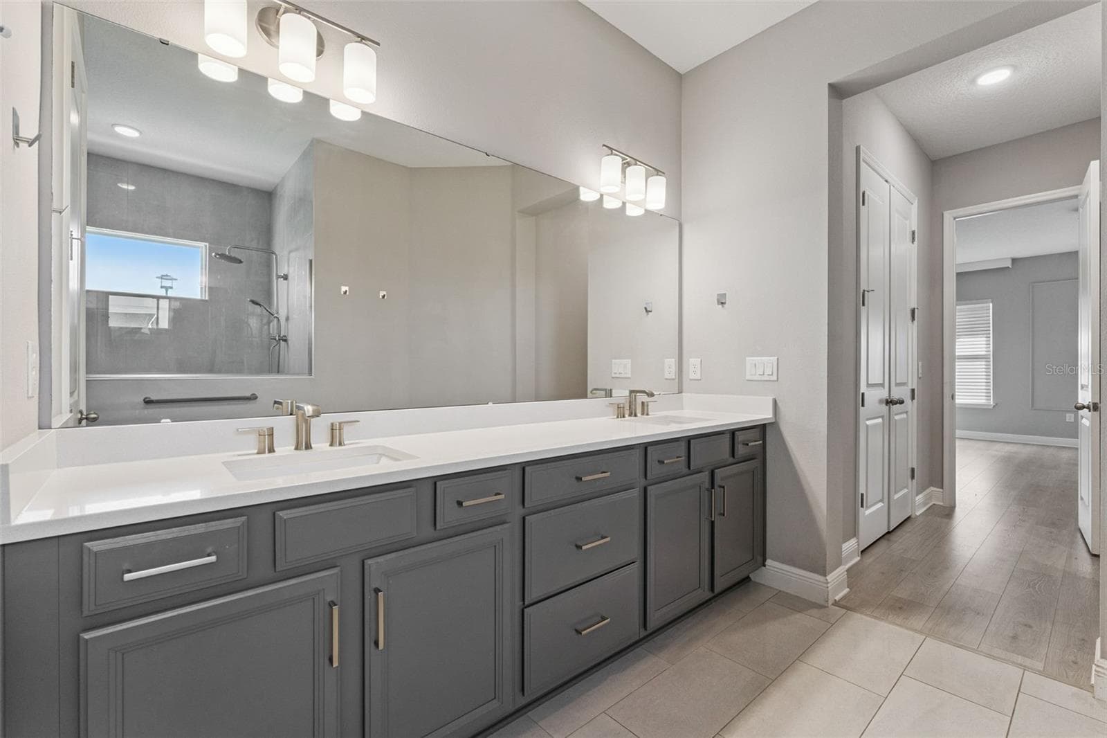 Primary bathroom featuring generous vanity space and modern finishes. - 19058 PLANETREE ST, ORLANDO