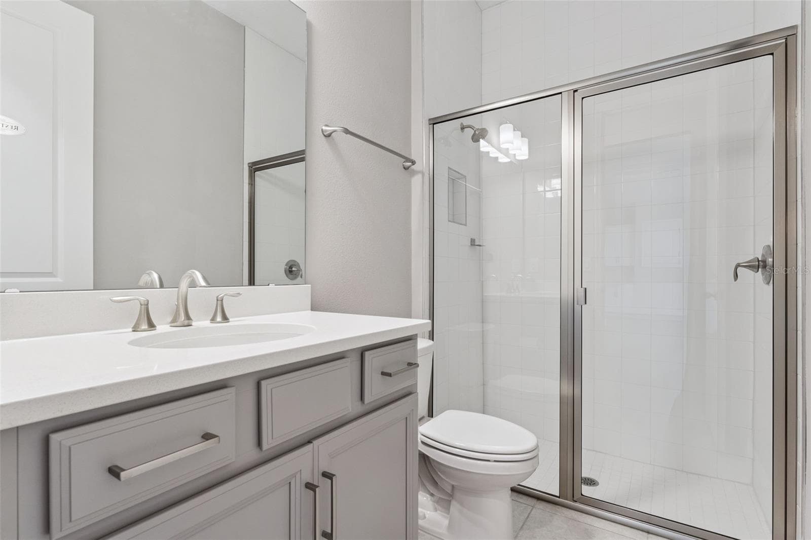 Full bathroom with modern vanity and tub/shower combination. - 19058 PLANETREE ST, ORLANDO