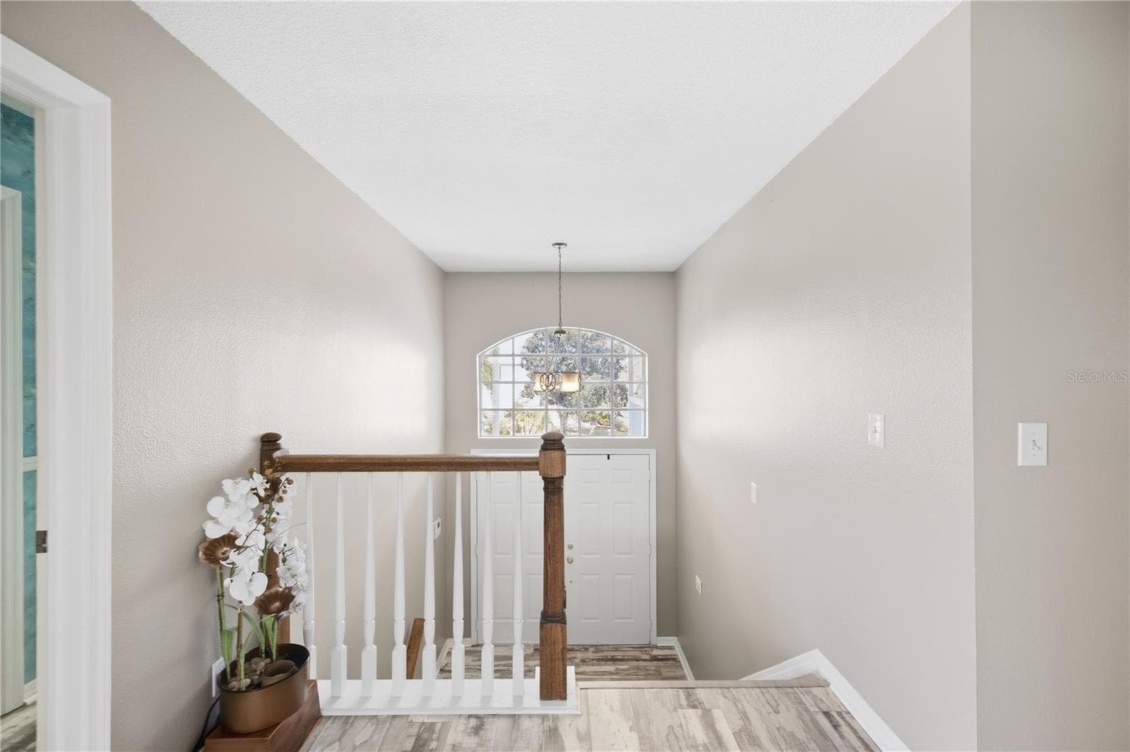 Foyer/Stairs at entry. Stairs lead up and down to each floor off the front of the home, as well as the back! - 6244 SPOONBILL DR, NEW PORT RICHEY