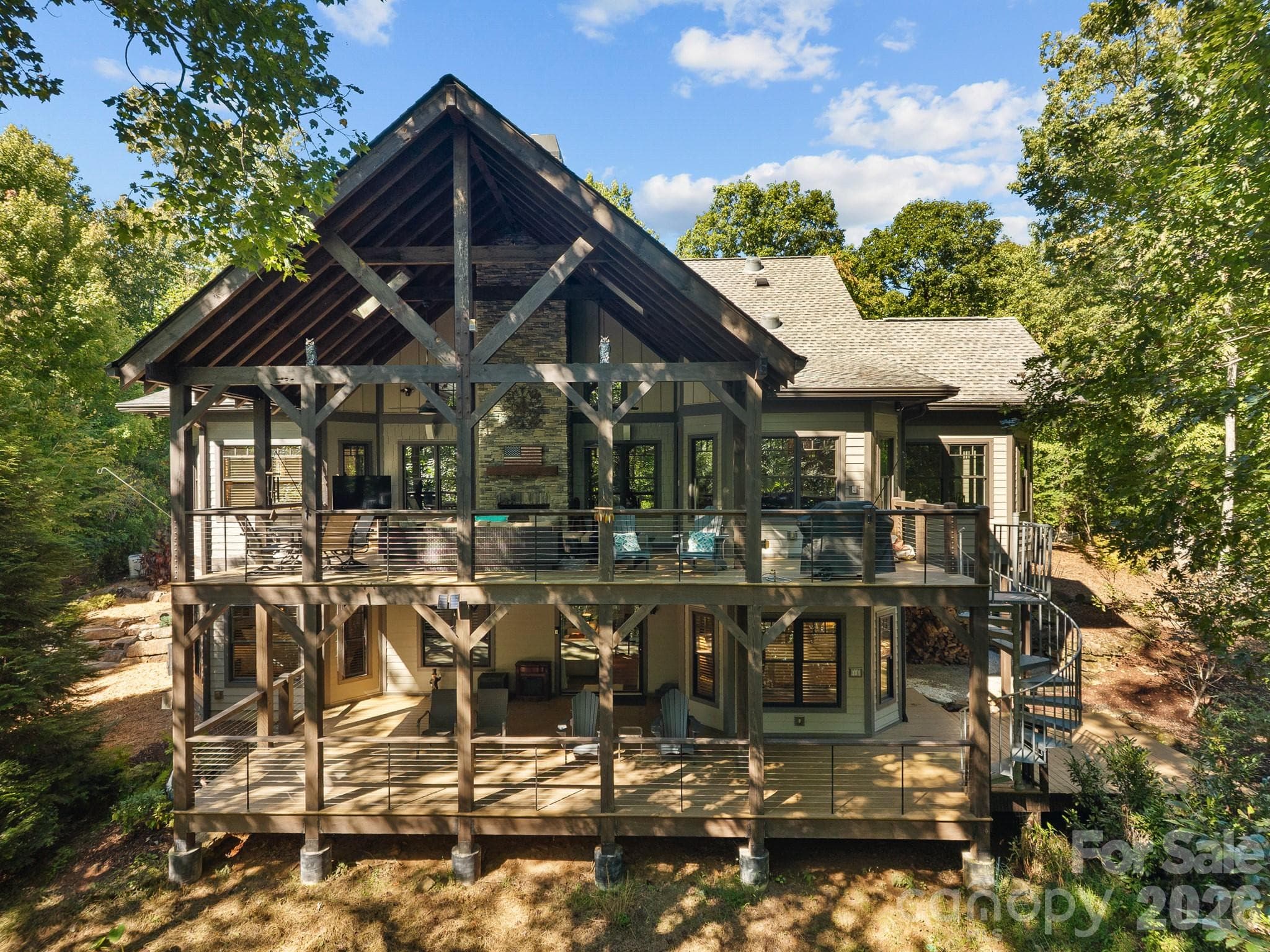 The outdoor spiral stairs allows the ability to traverse the decks from the outside - 359 New Castle Road, Brevard