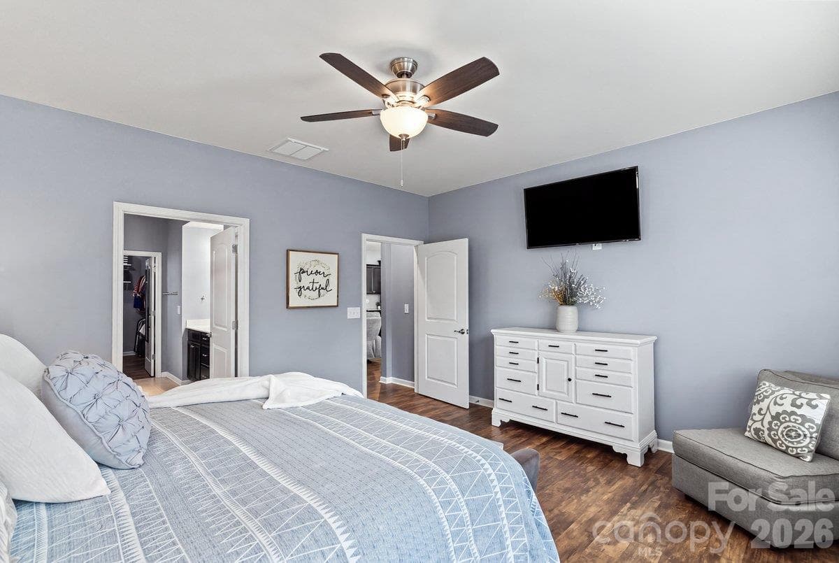 Primary suite on the main level, privately tucked away at the rear of the home. - 2003 Harvest Time Lane, Waxhaw