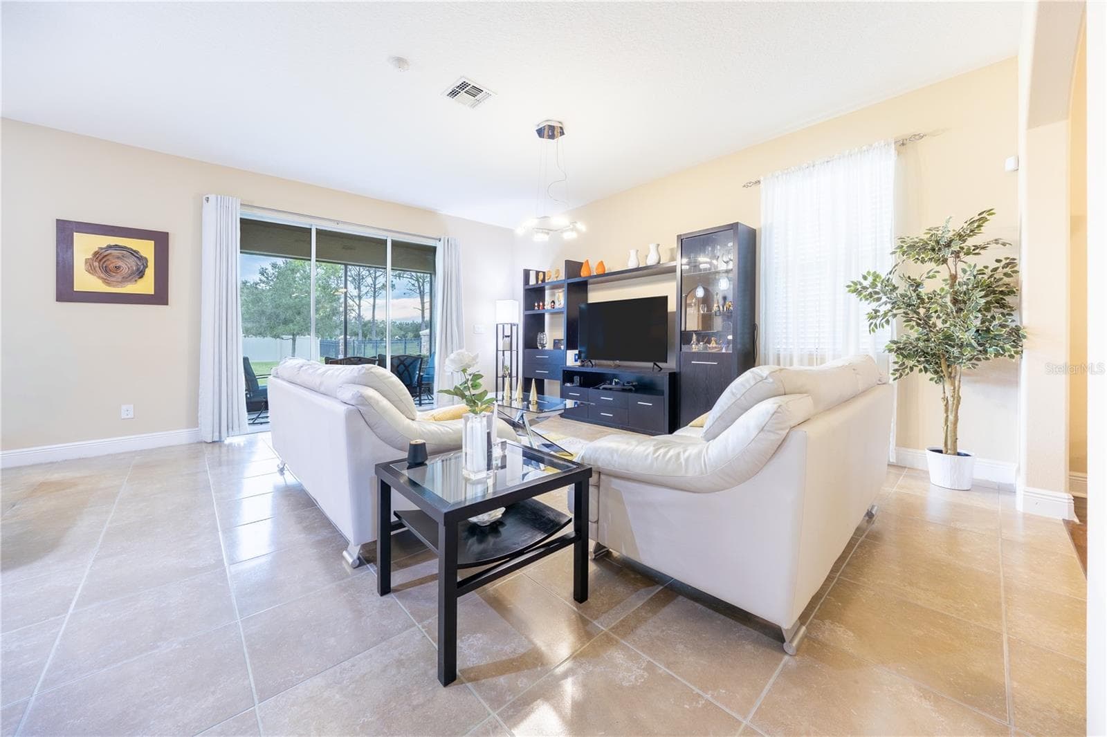 Open-concept living room with soaring ceilings and sliding glass doors - 3048 BOATING BLVD, KISSIMMEE