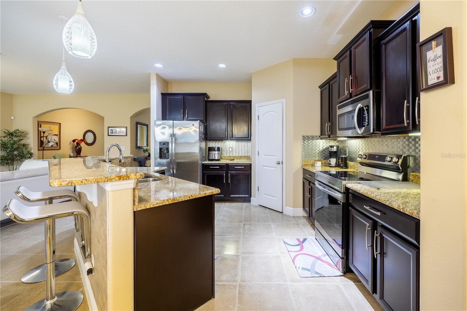Kitchen with ample cabinet space, open to the living area - 3048 BOATING BLVD, KISSIMMEE
