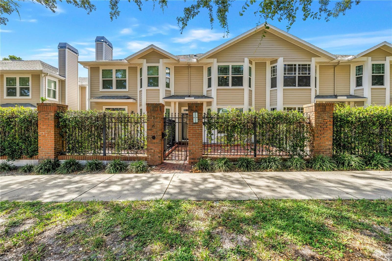 Front exterior of this beautifully updated residence with a private gated brick courtyard and 2-car garage. - 350 2ND ST N #6, ST PETERSBURG