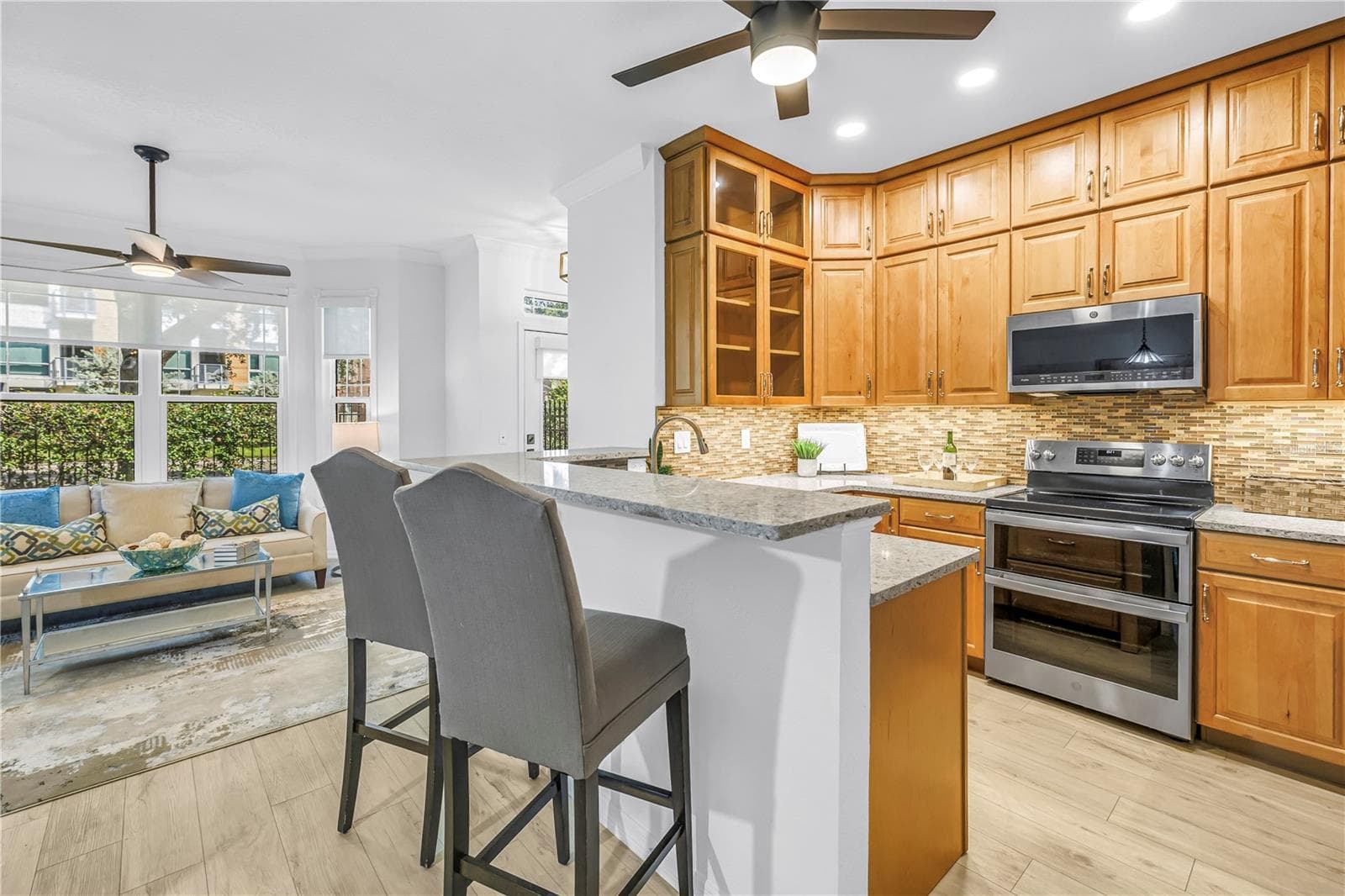 Another view of the renovated kitchen shows its generous cabinetry and easy connection to the front entry and main living areas. - 350 2ND ST N #6, ST PETERSBURG