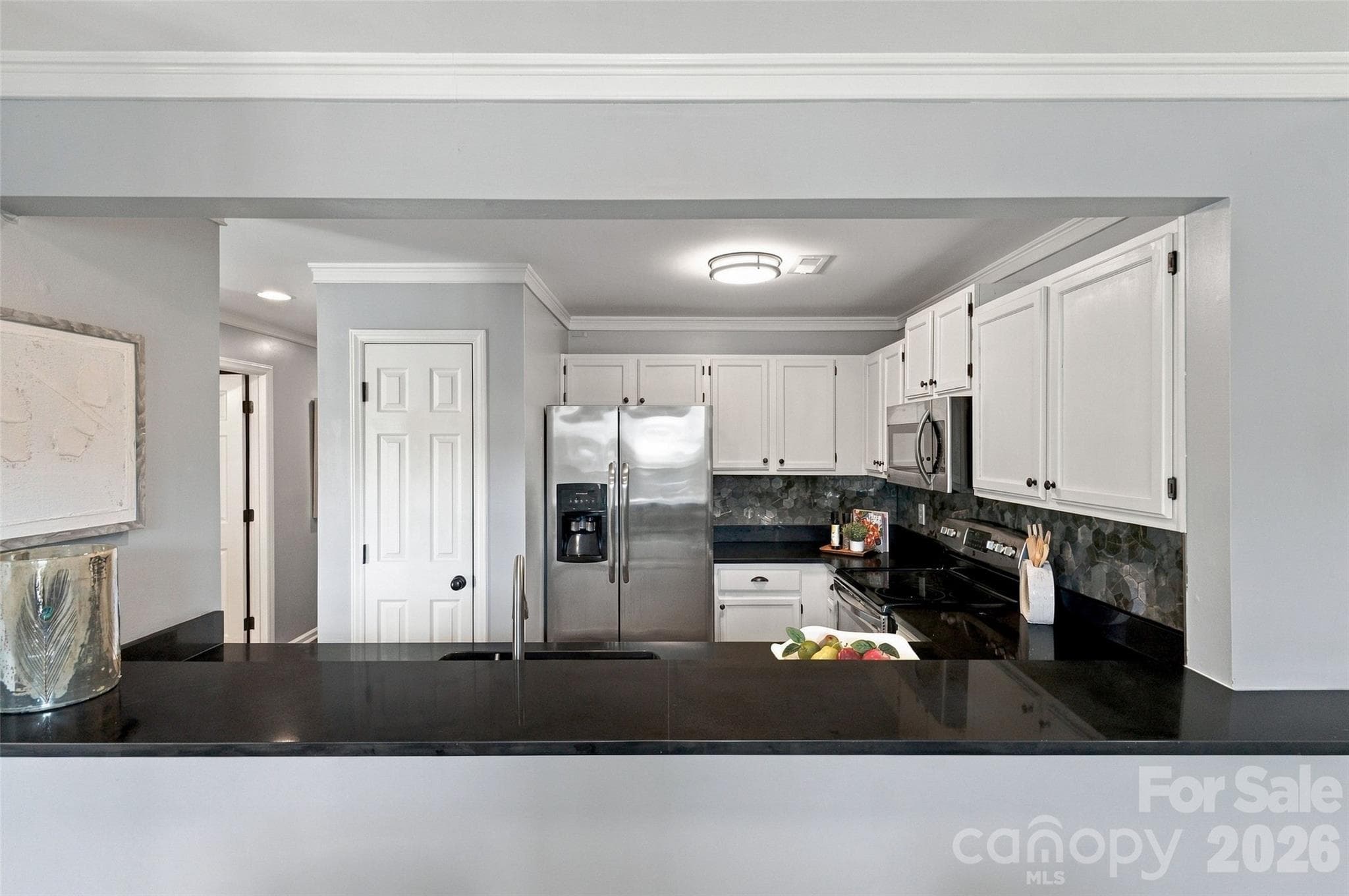 Kitchen with white cabinetry, new countertops and stainless steel appliances - 762 Marsh Road, Charlotte