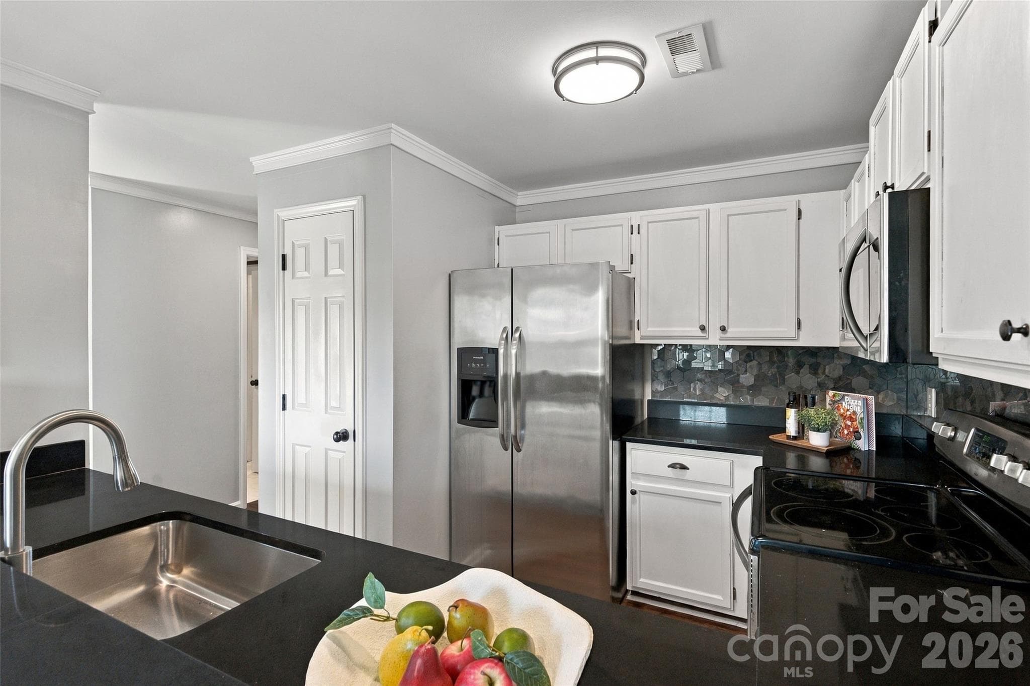 Kitchen with white cabinetry, new countertops and stainless steel appliances - 762 Marsh Road, Charlotte