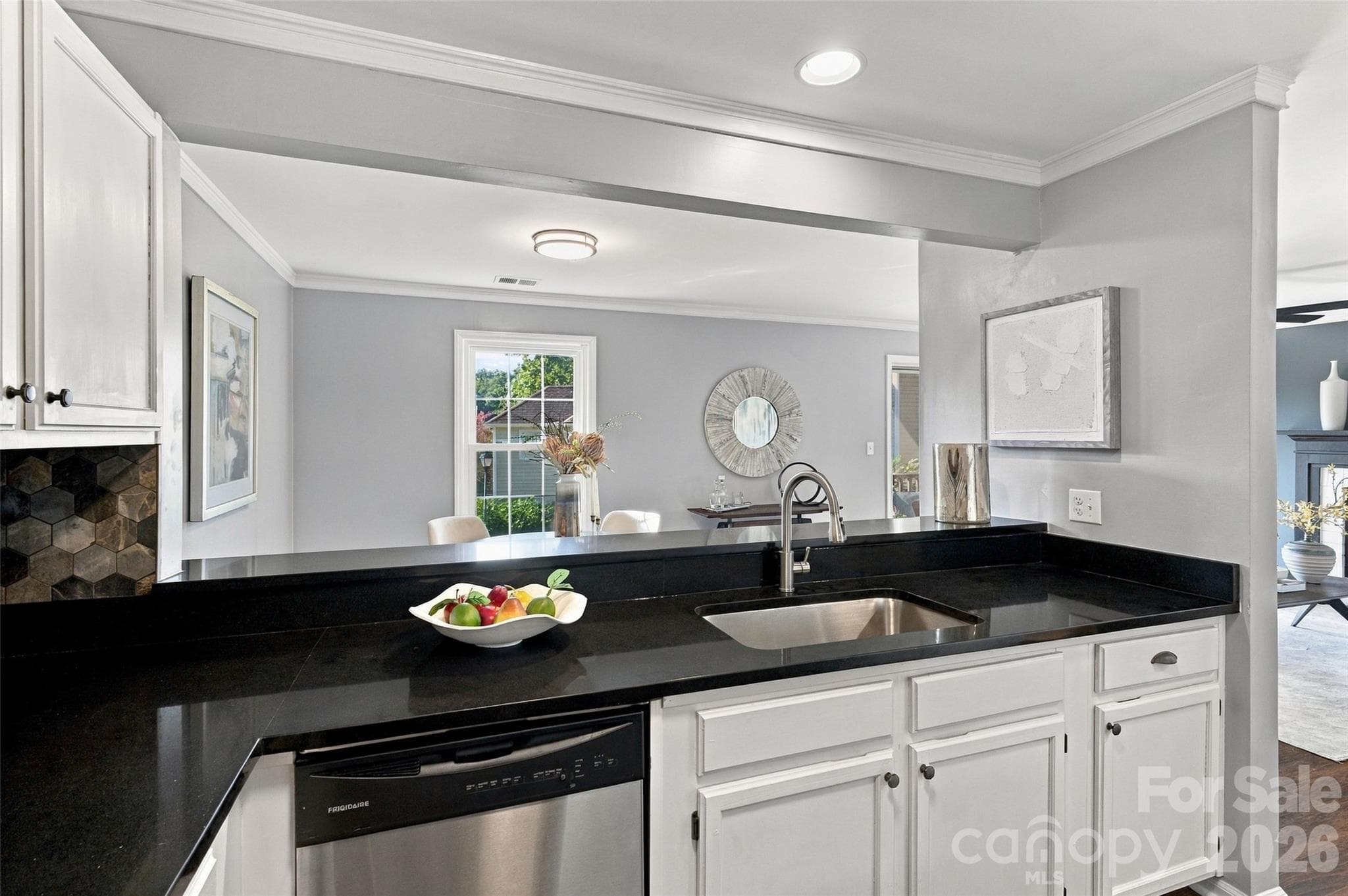Kitchen sink overlooks the dining area through the open breakfast bar - 762 Marsh Road, Charlotte
