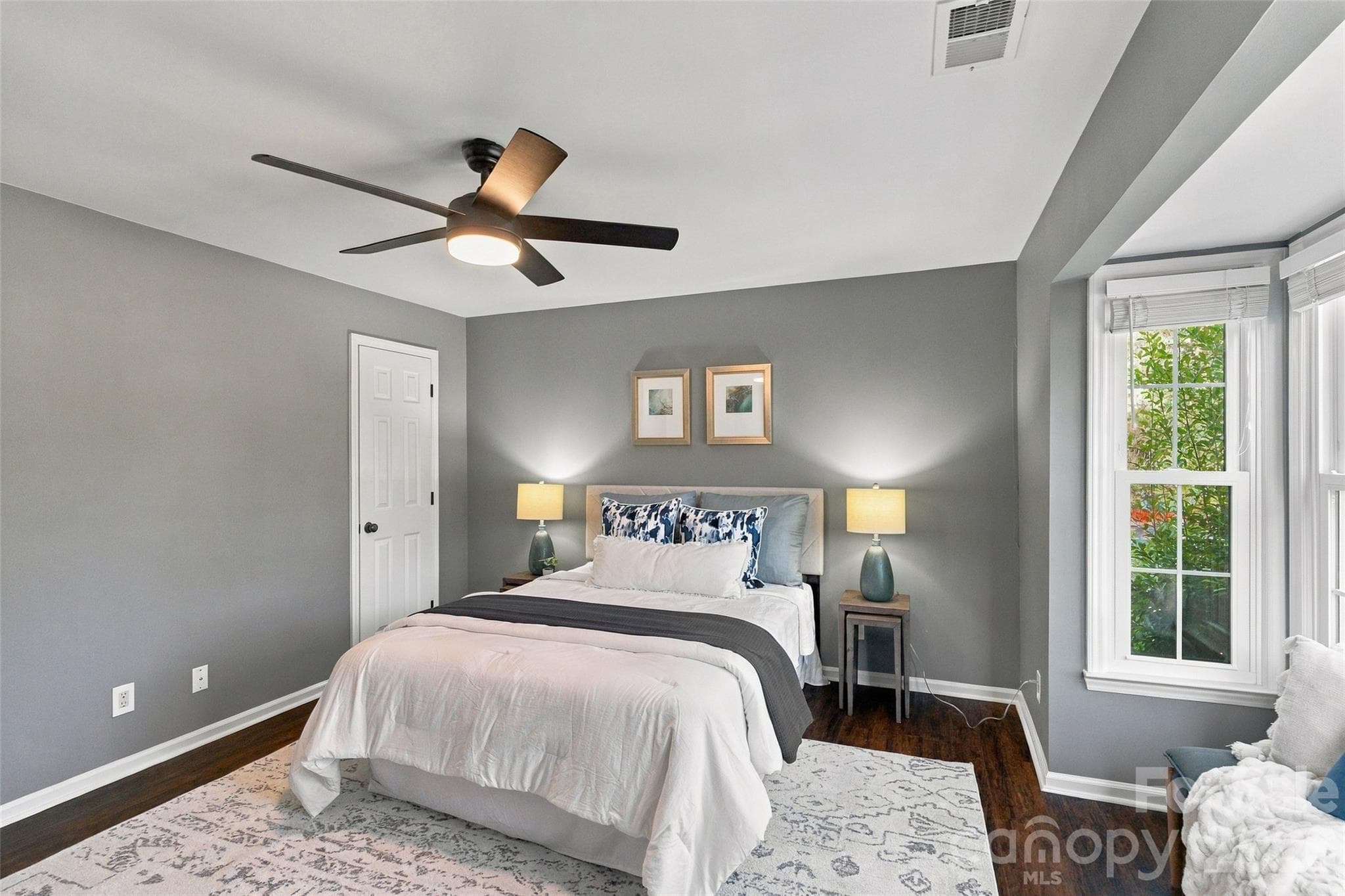 Spacious primary bedroom with ceiling fan and abundant natural light - 762 Marsh Road, Charlotte