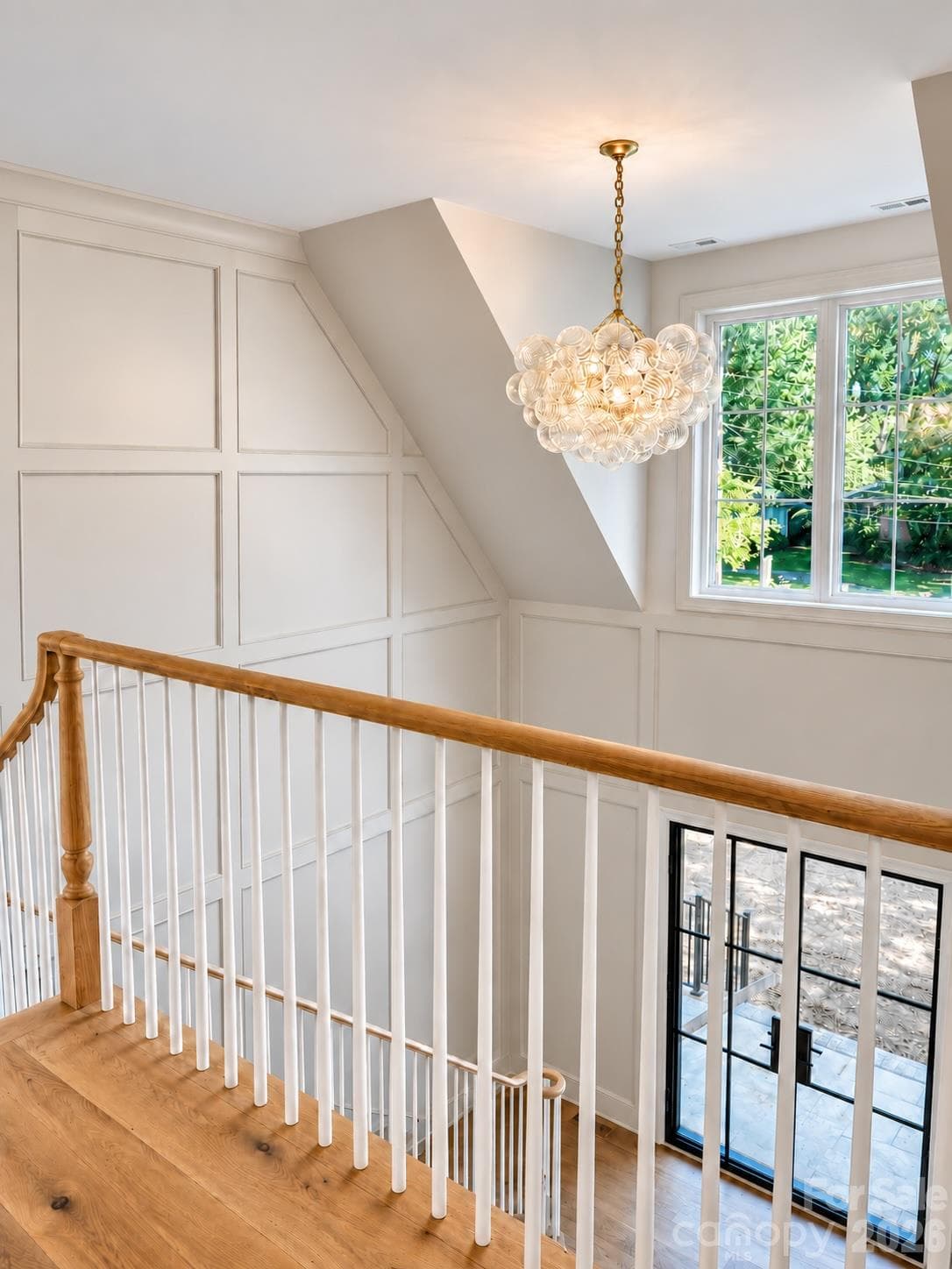 Dramatic two-story foyer with custom panel molding and statement staircase. - 125 Randstone Court, Charlotte