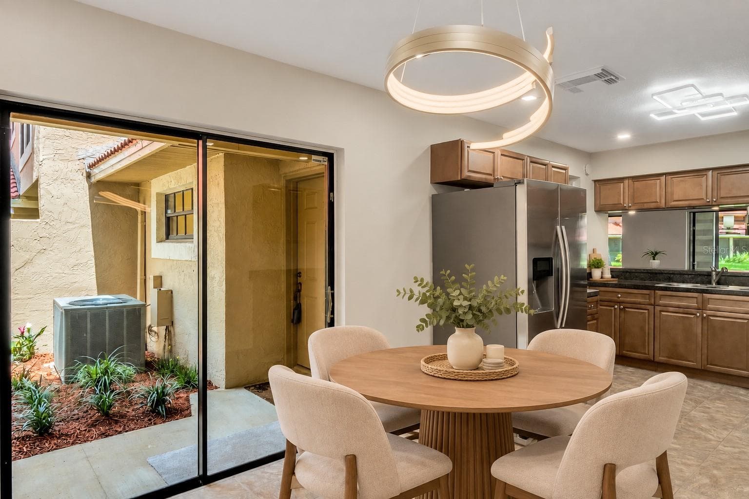 Casual dining area beside the kitchen with sliding-door access outdoors. - 8235 AMBROSE COVE WAY, ORLANDO