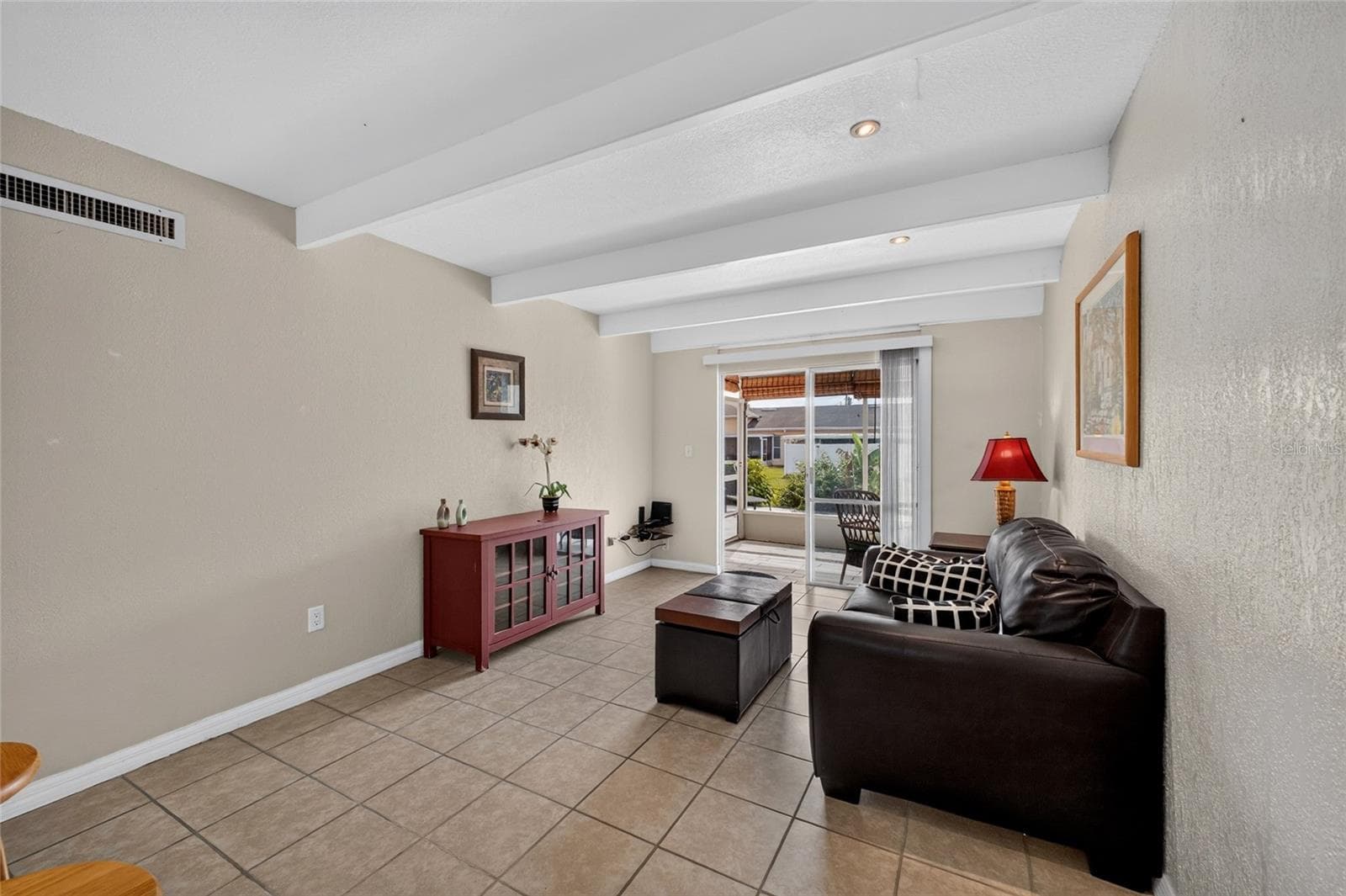 Sliding glass door at the end of the living room allows natural light to filter inside the home. - 4409 CLUB CIR, LAKE WALES