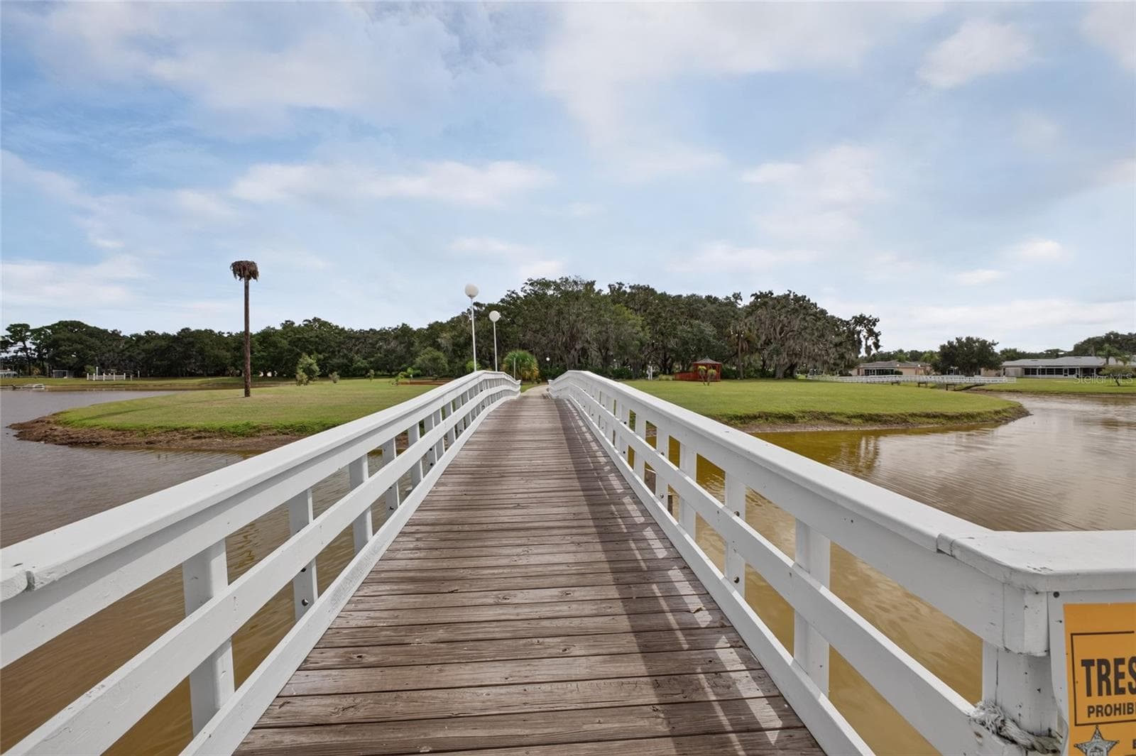 Heading over the bridge to the "Island". Outdoor amenities are located on the Island and easily accessible from all homes. - 4409 CLUB CIR, LAKE WALES