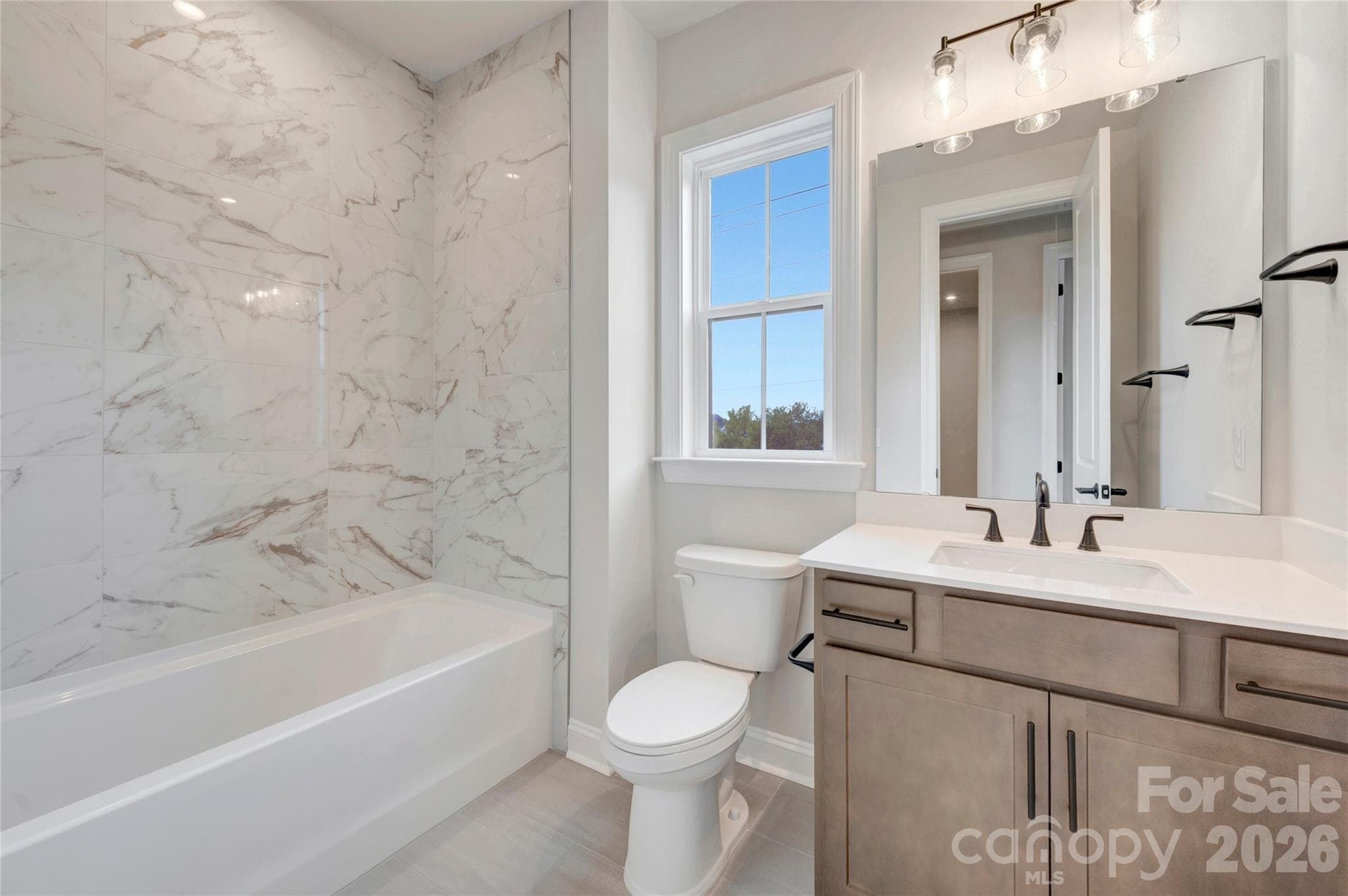 Secondary bathroom with tiled walls above the tub - 13023 Lucy Park Lane, Charlotte