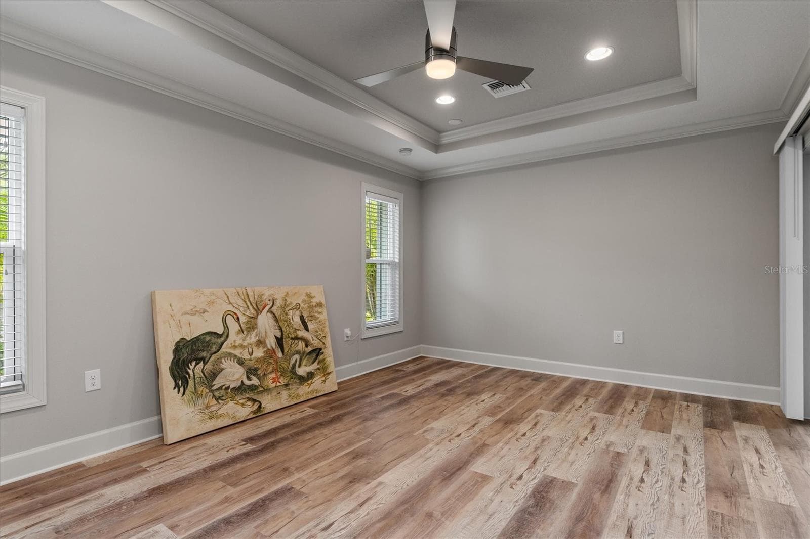 Tray ceiling, high hats light and bright spacious primary bedroom - 2420 SHEILA LN, NORTH PORT