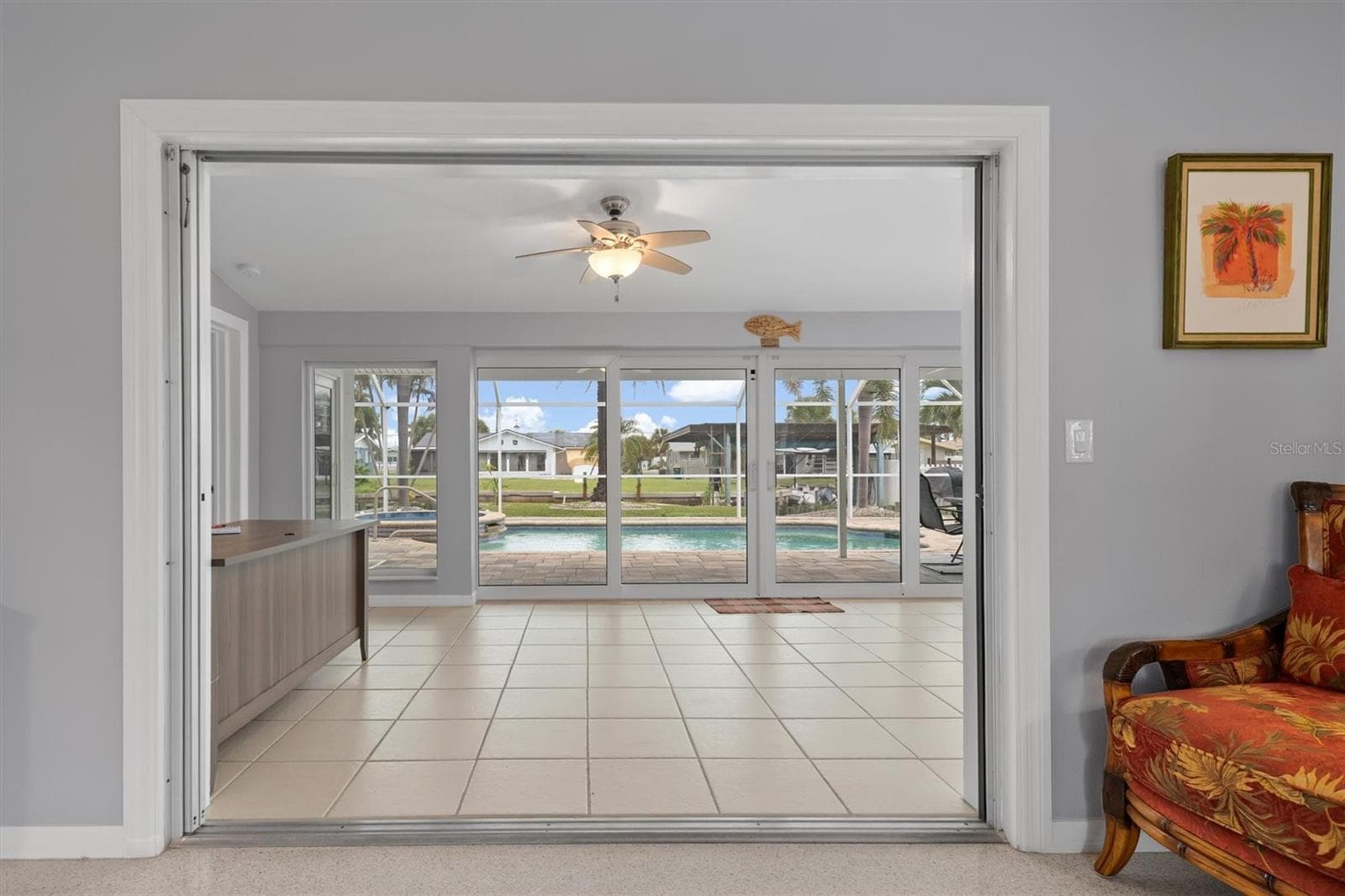 looking from living room thru enclosed Florida room and out to pool and canal - 1433 LEMON BAY DR, ENGLEWOOD