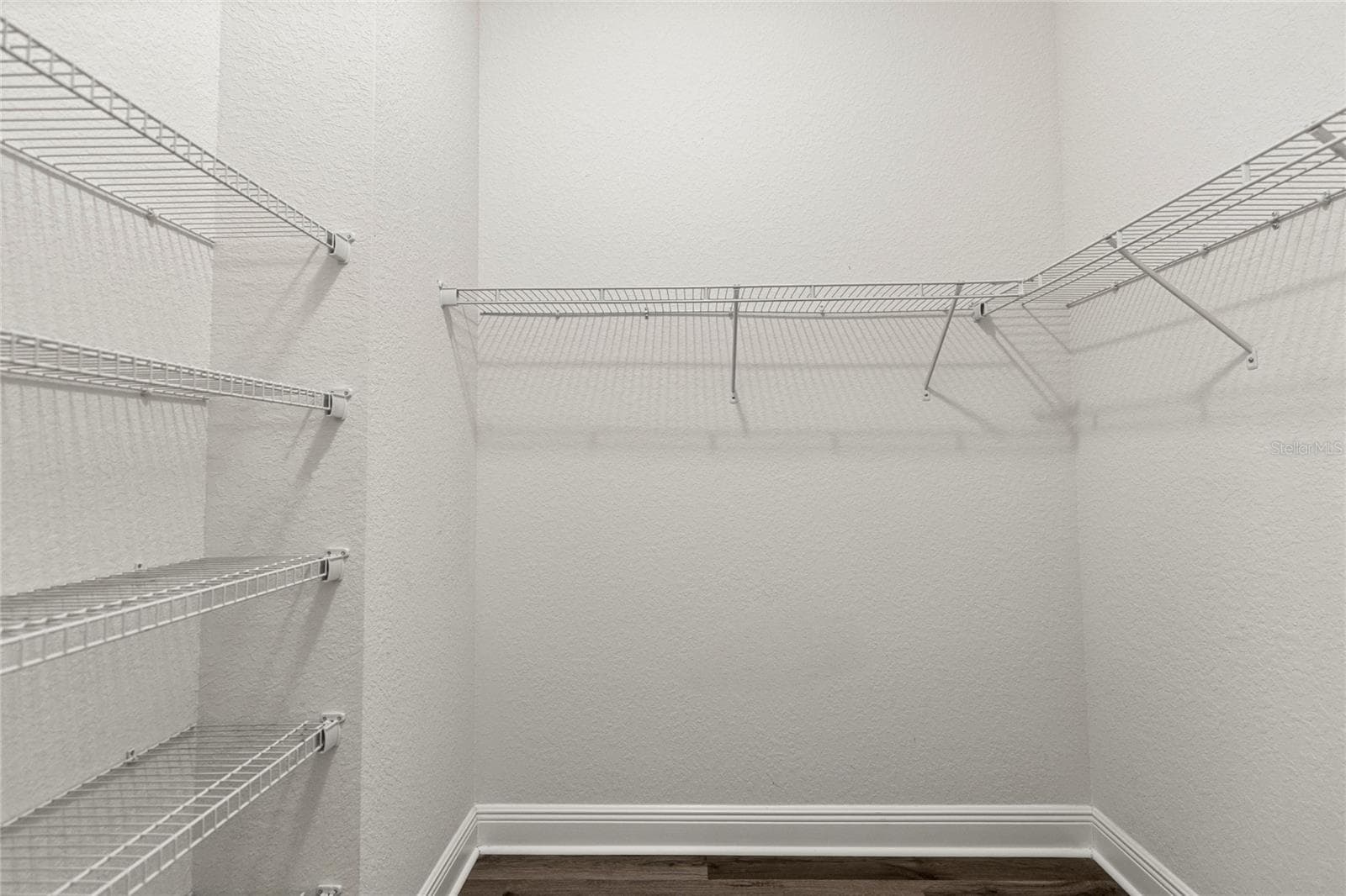 His Walk-In Closet. - 1126 MIONA SHORES DR, THE VILLAGES