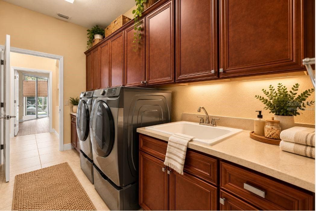 Virtually staged Indoor Laundry Room with Custom Cabinetry, Utility Sink, and Folding Counter. - 1126 MIONA SHORES DR, THE VILLAGES