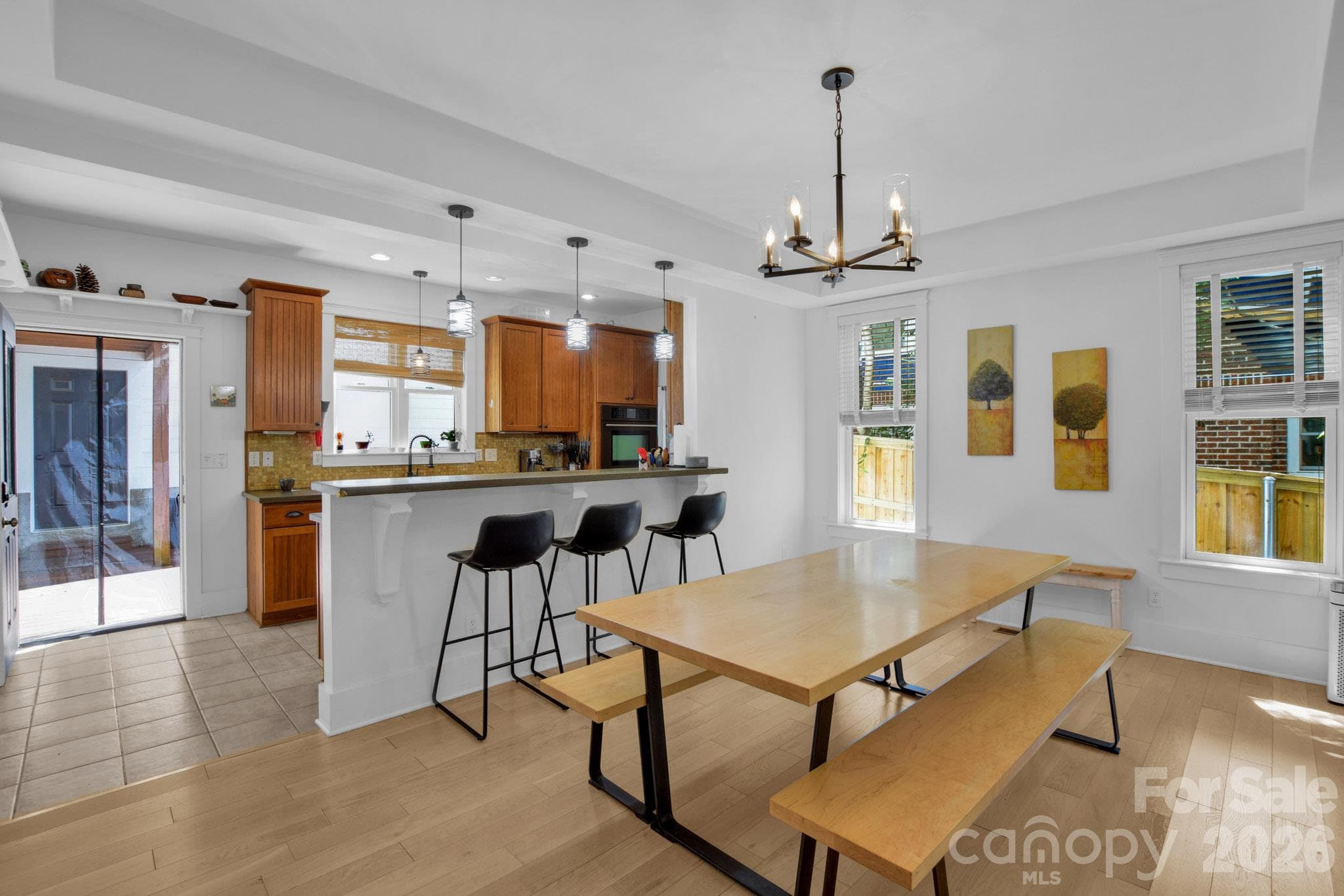 Dining area with natural light and lovely lighting fixtures - 92 Rumbough Place, Asheville