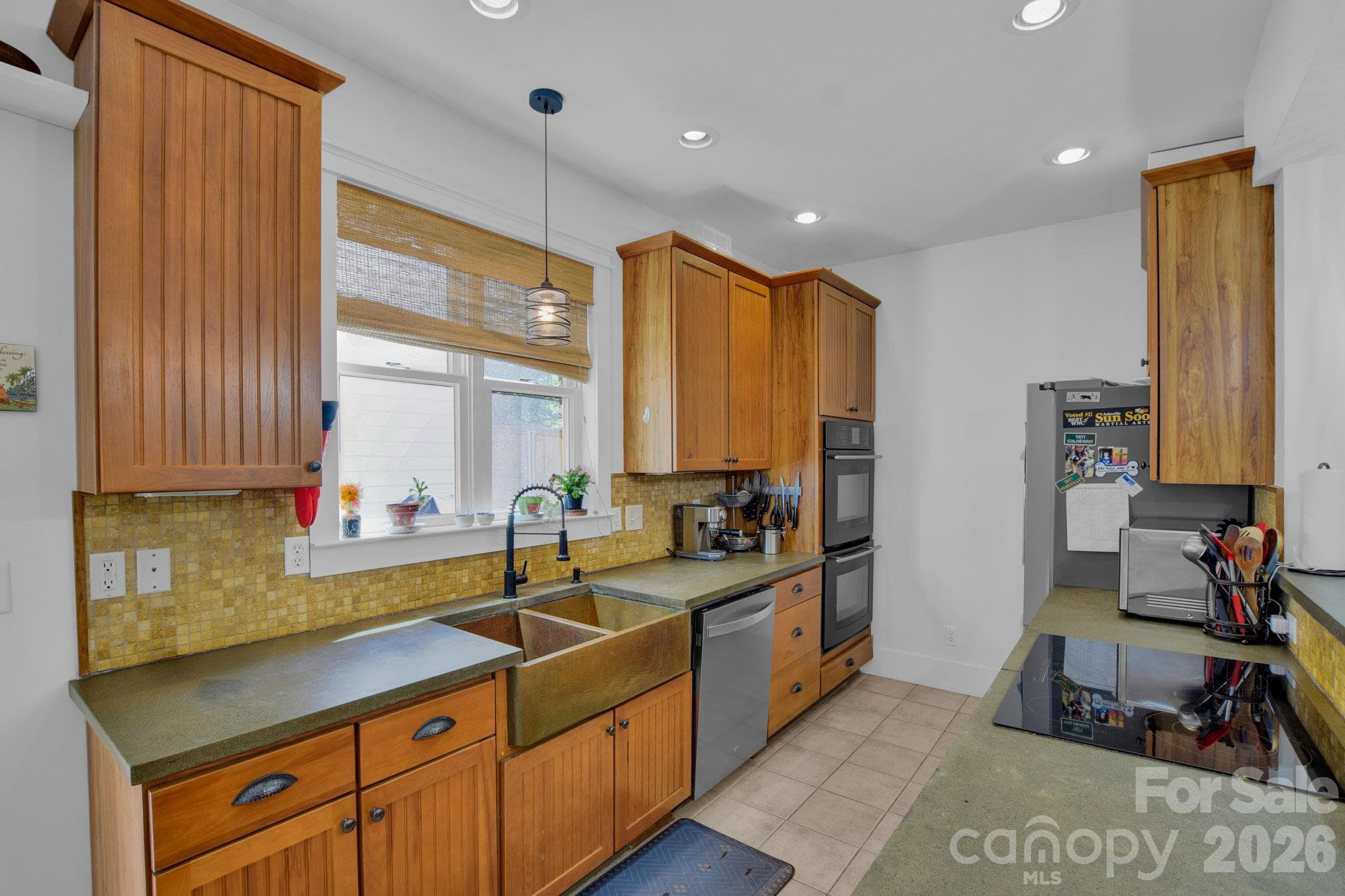 A spacious galley kitchen with a Jenn-Air double oven, Whirlpool glass cooktop and Dishwasher - 92 Rumbough Place, Asheville