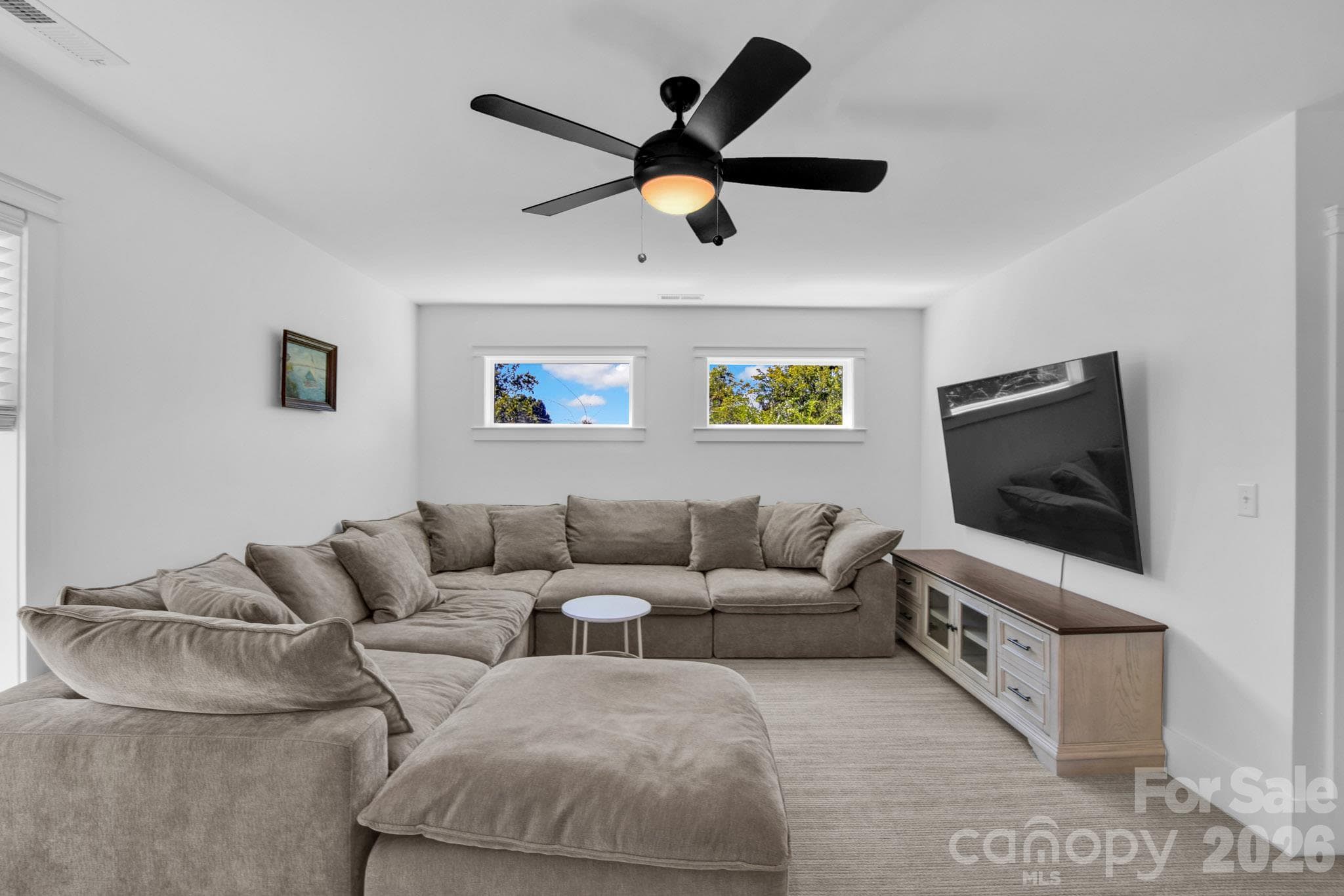 Get cozy on the 2025 addition of the 3rd level. An extra living space for everyone to spread out. - 92 Rumbough Place, Asheville