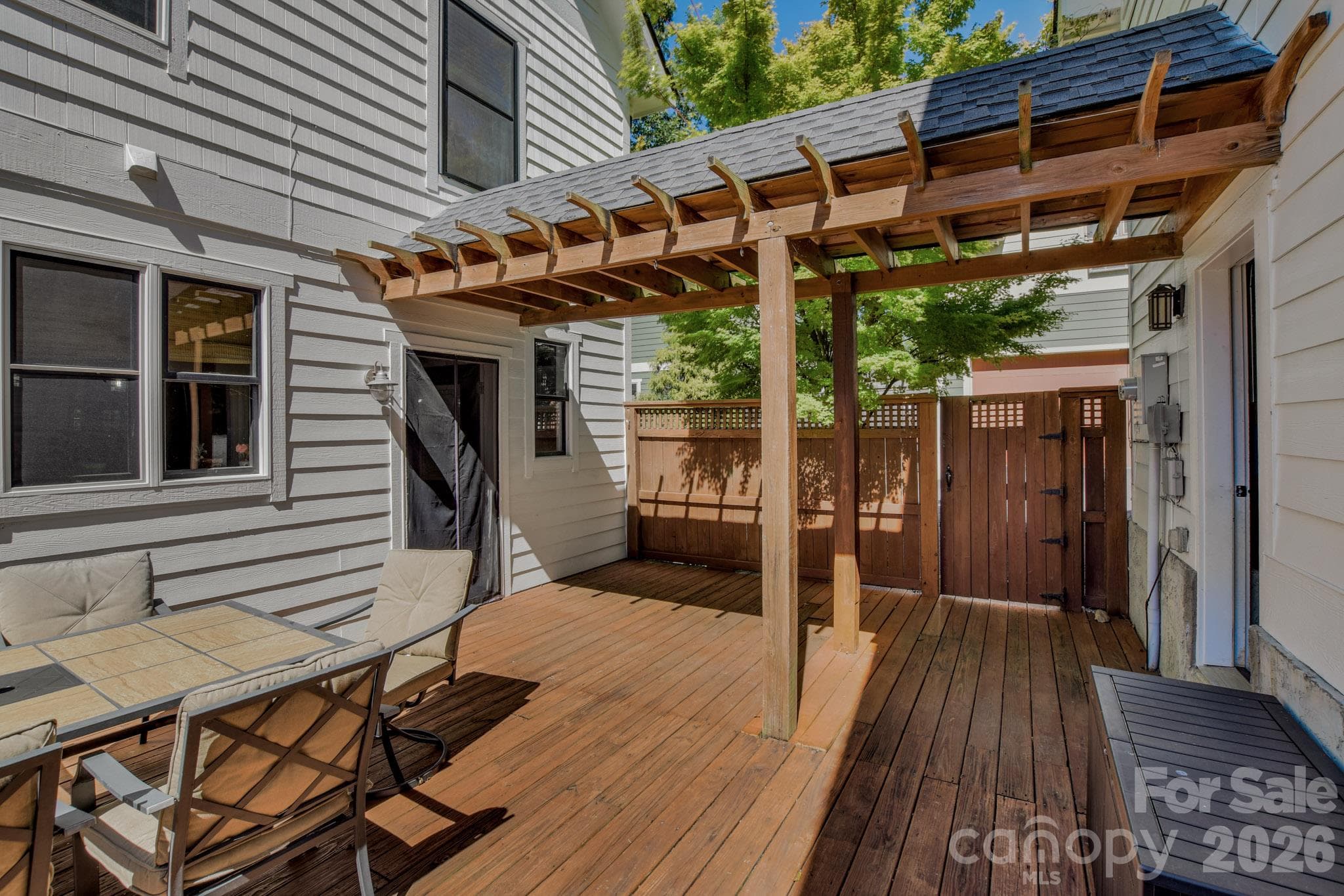 Patio connects to the 2-car garage and has a gate to the driveway - 92 Rumbough Place, Asheville
