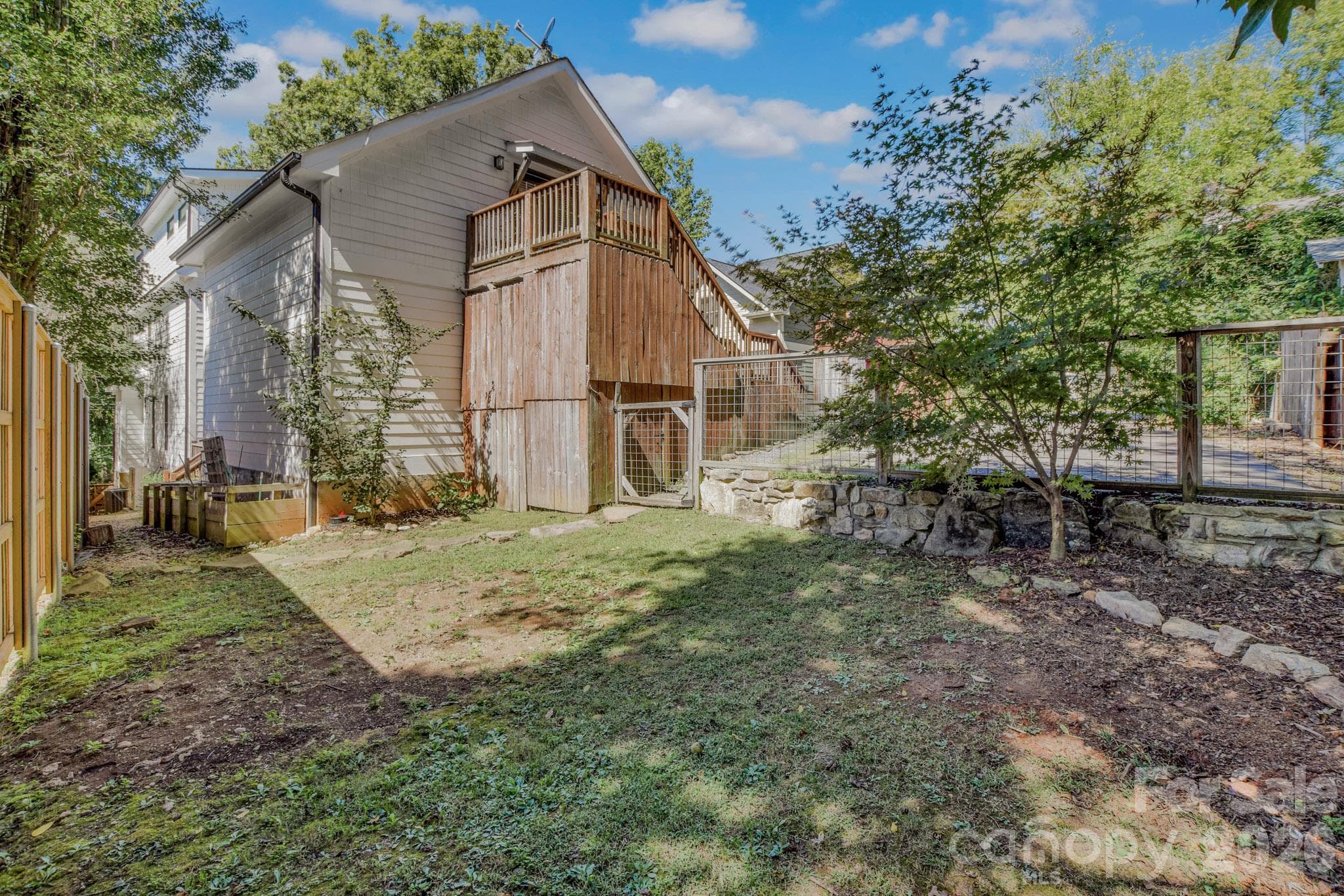A brand new privacy fence surrounds the back yard with enough space for a play set, garden beds, or a trampoline - 92 Rumbough Place, Asheville