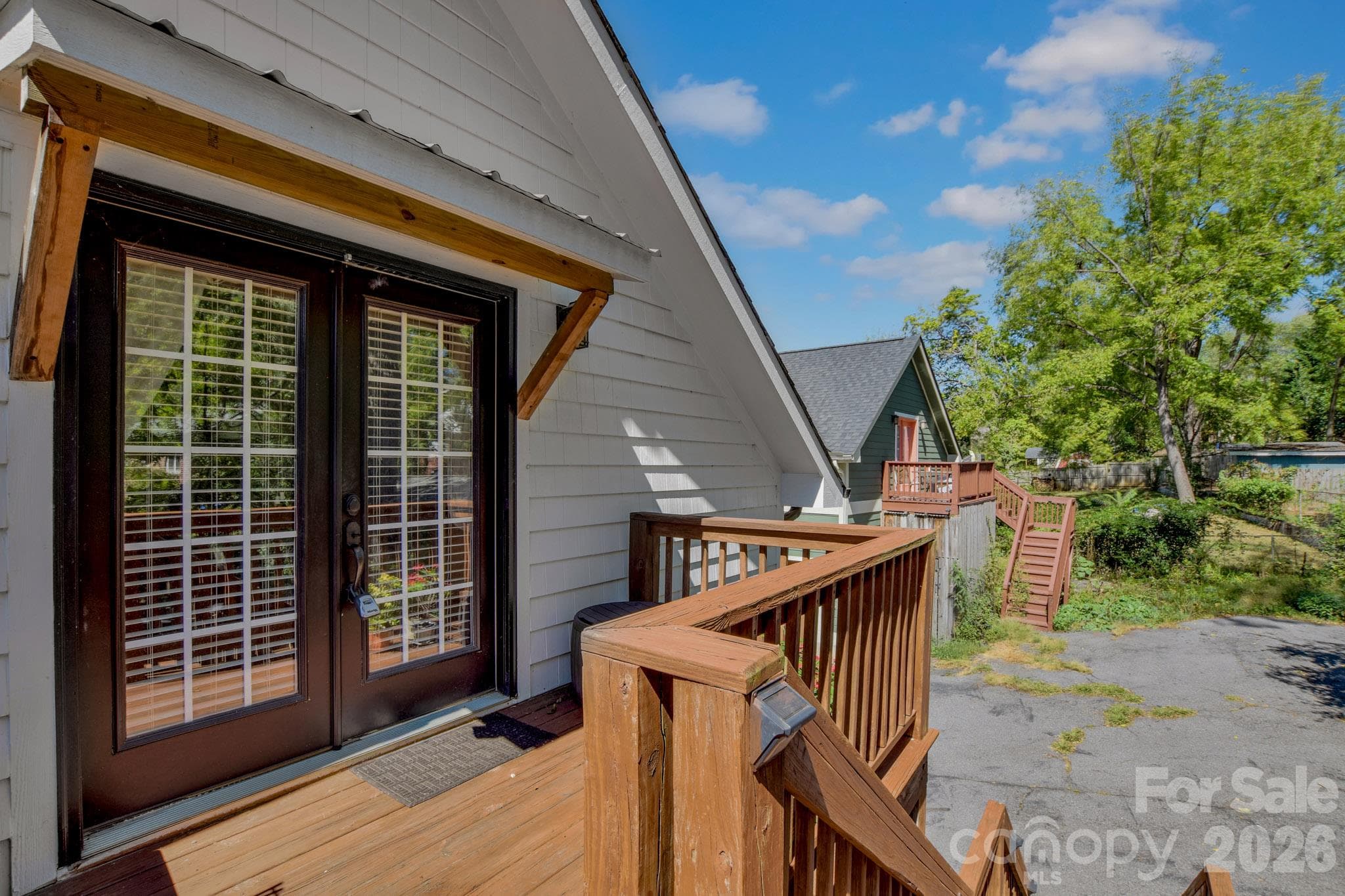 Stairs lead to the ADU, a studio 1bed/1 bath with separately metered utilities - 92 Rumbough Place, Asheville